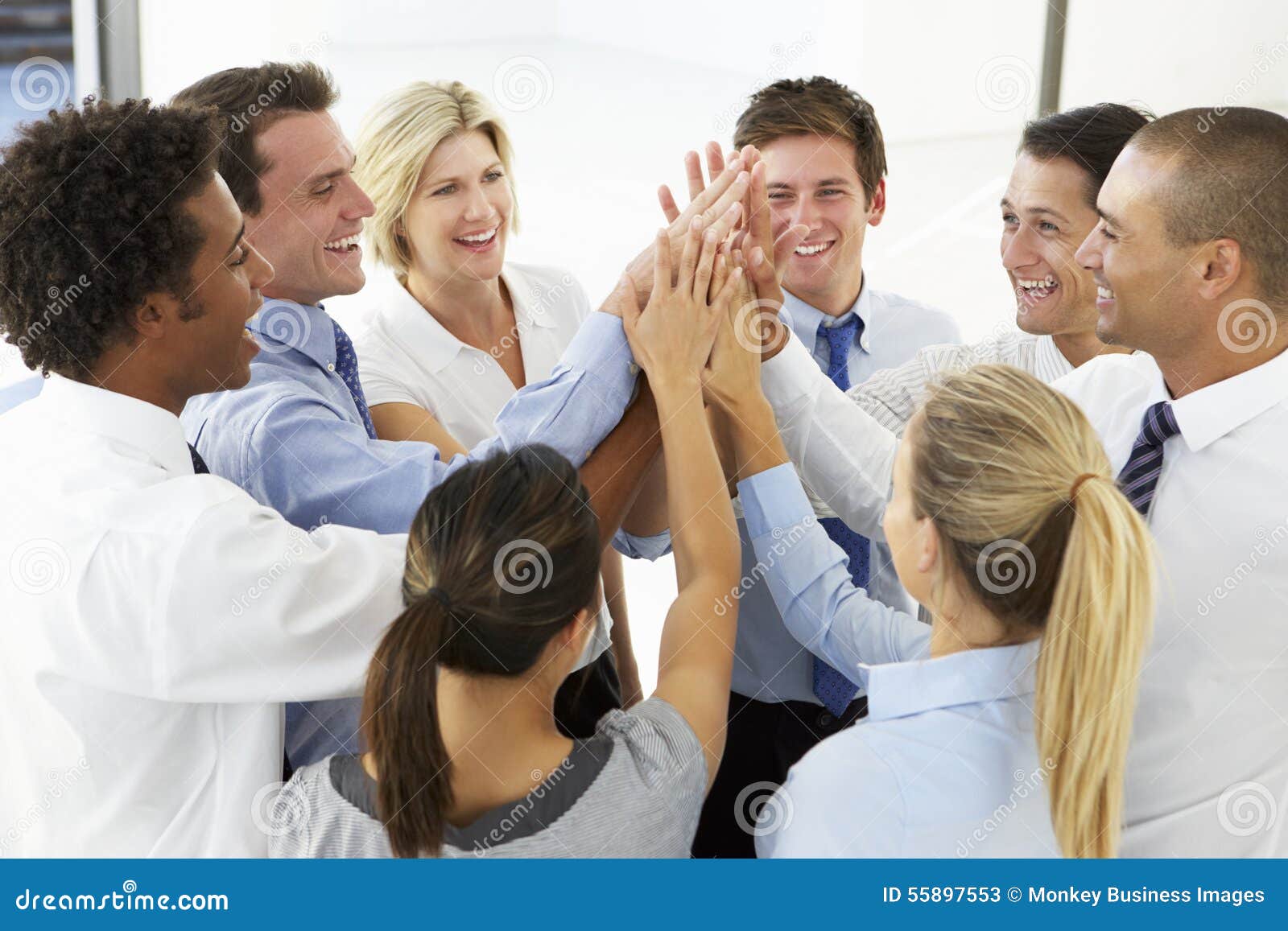 close up of business people joining hands in team building exercise