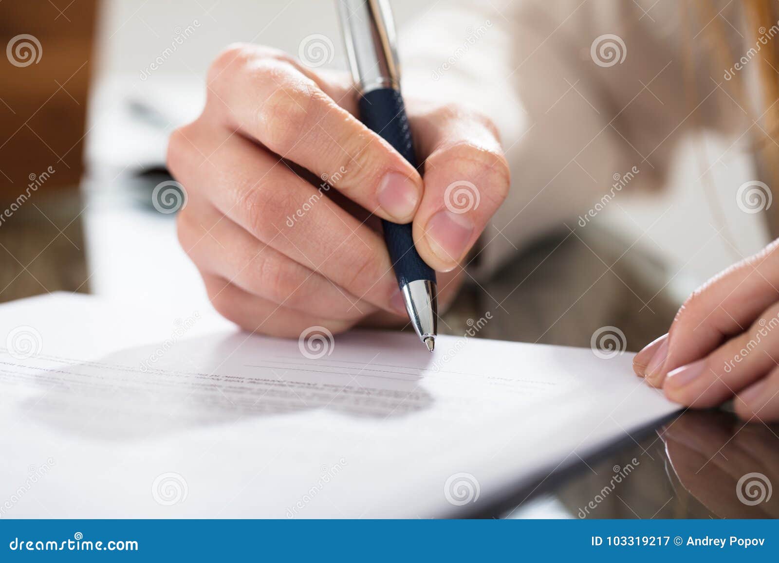 business person signing document with pen