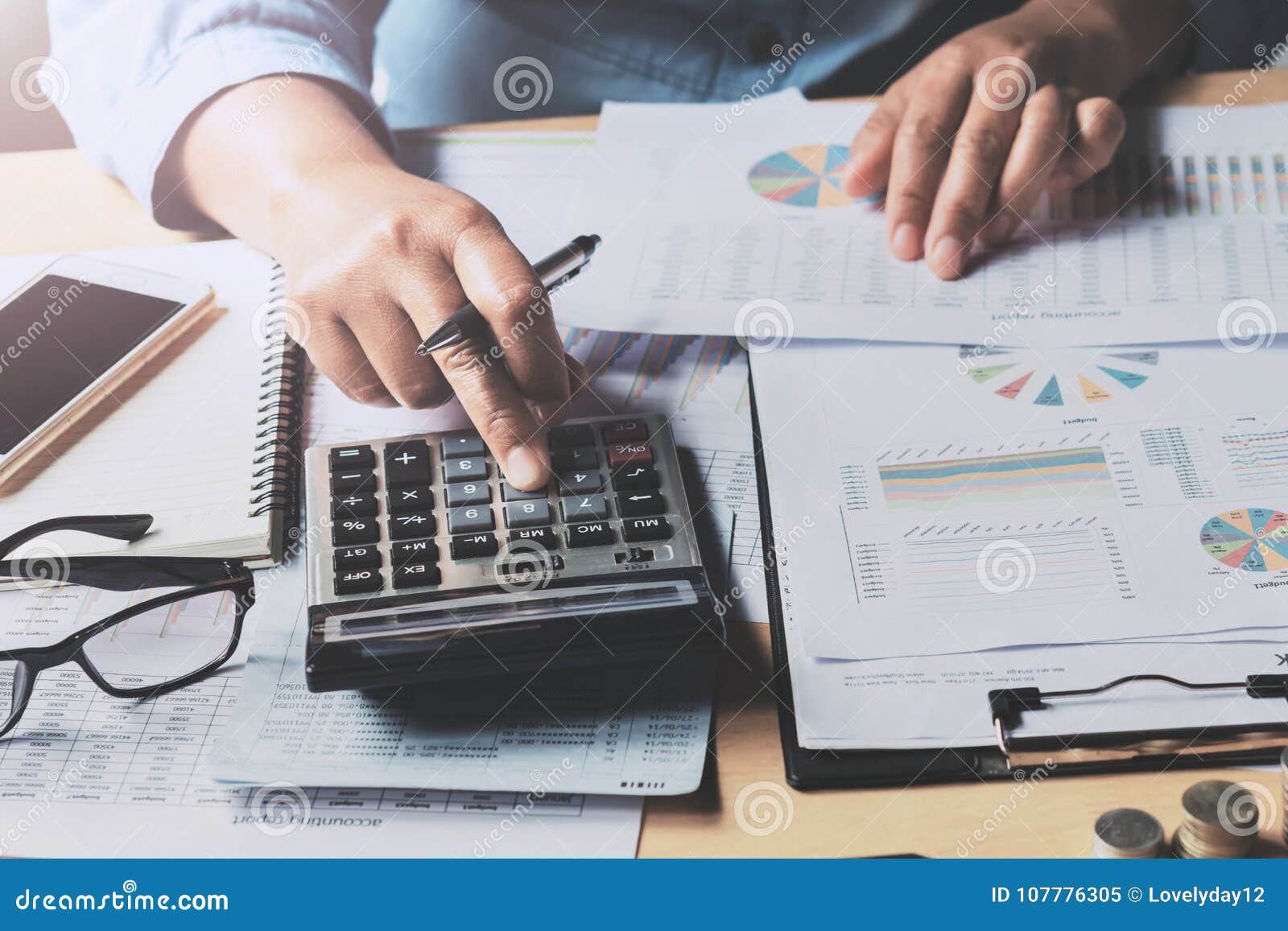 close up business woman using calculator to calculate data