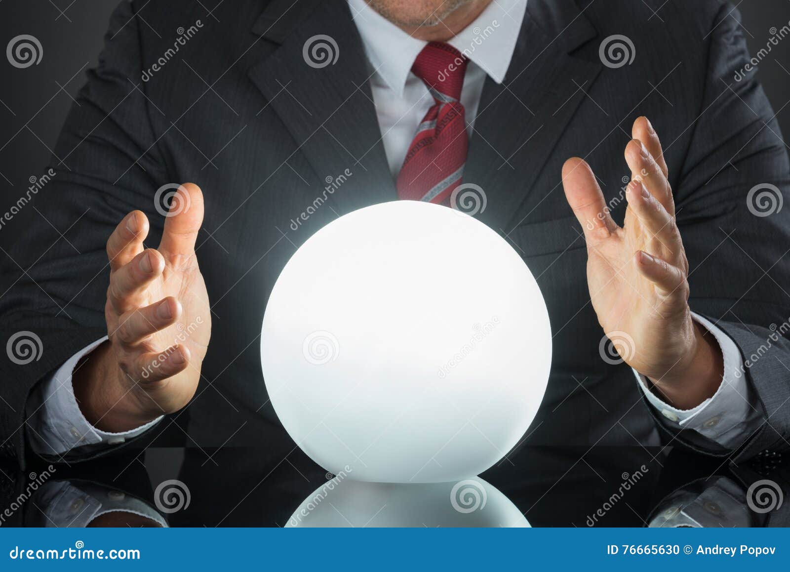 close-up of businessman hand on crystal ball