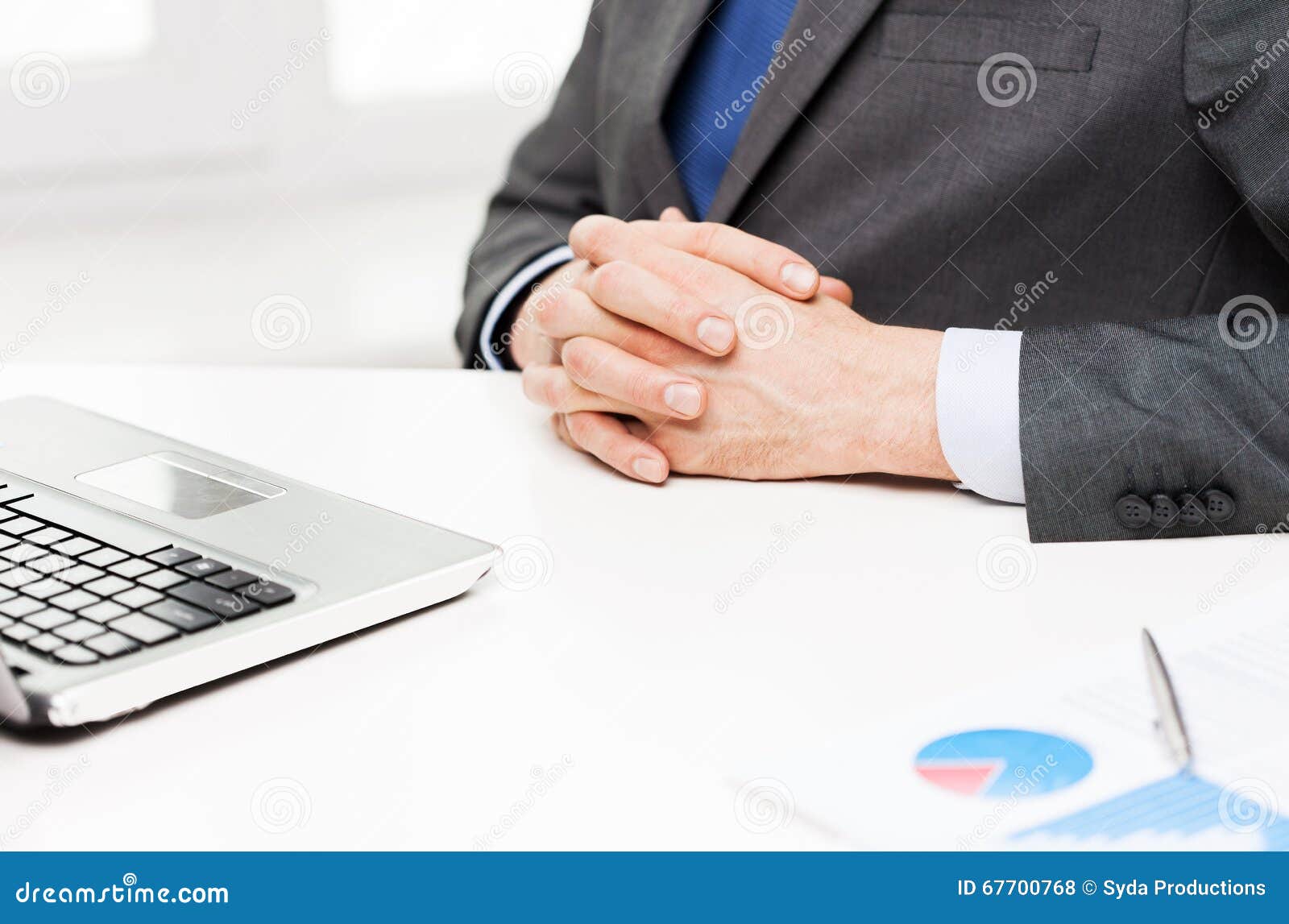 close up of businessman with laptop and papers