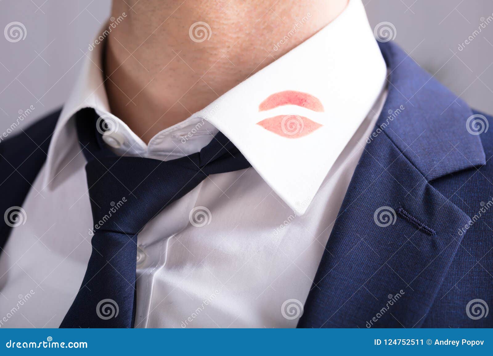 businessman with lipstick kiss marks on shirt`s collar