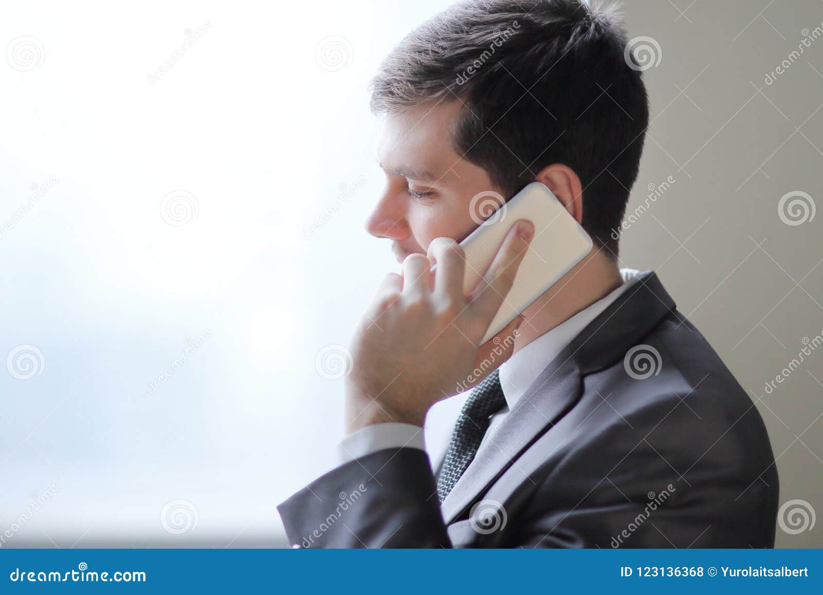 Close Up.businessman Talking On Smartphone While Standing Near An Office Window Stock Photo ...