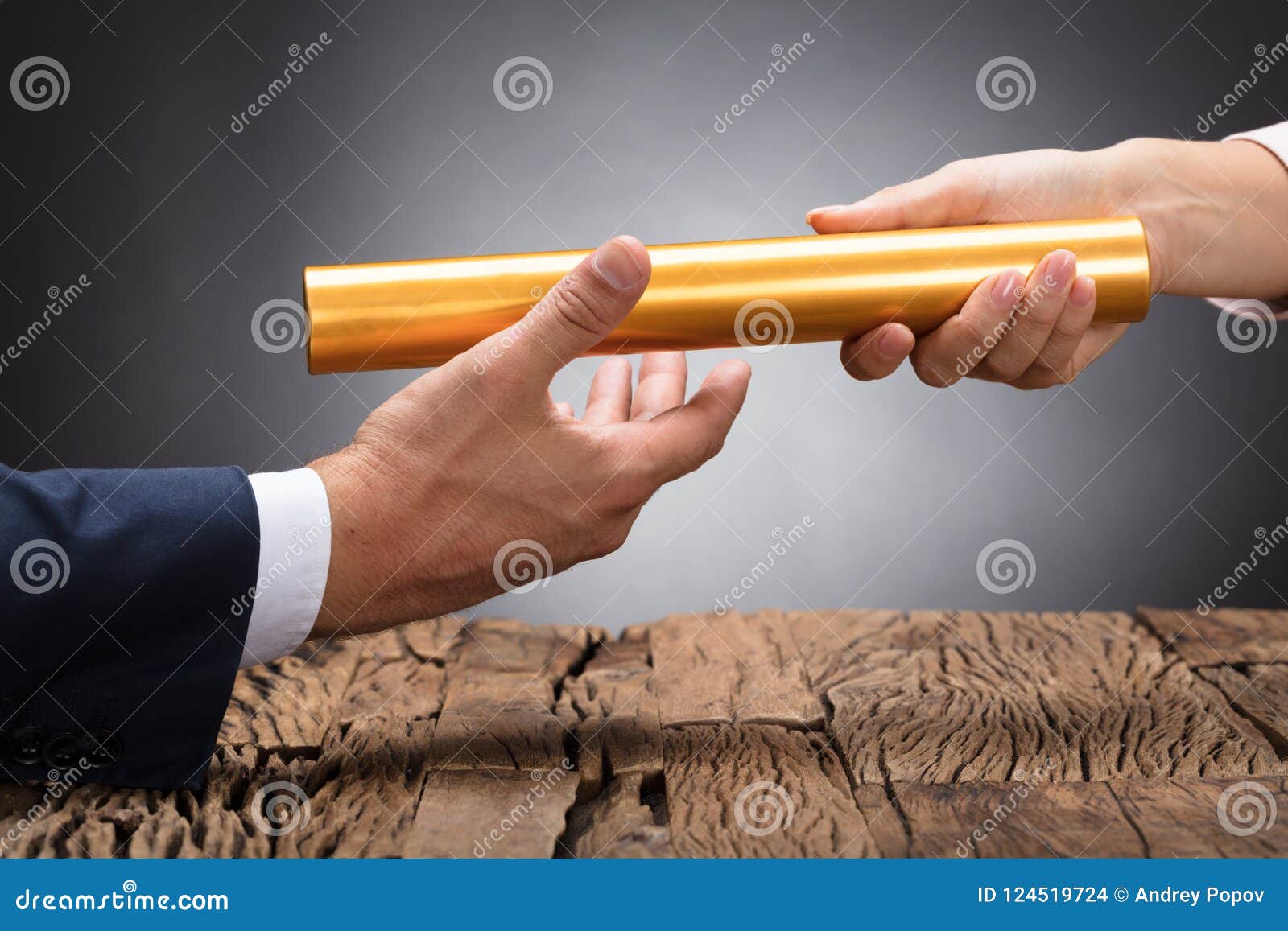 close-up of a businessperson passing baton