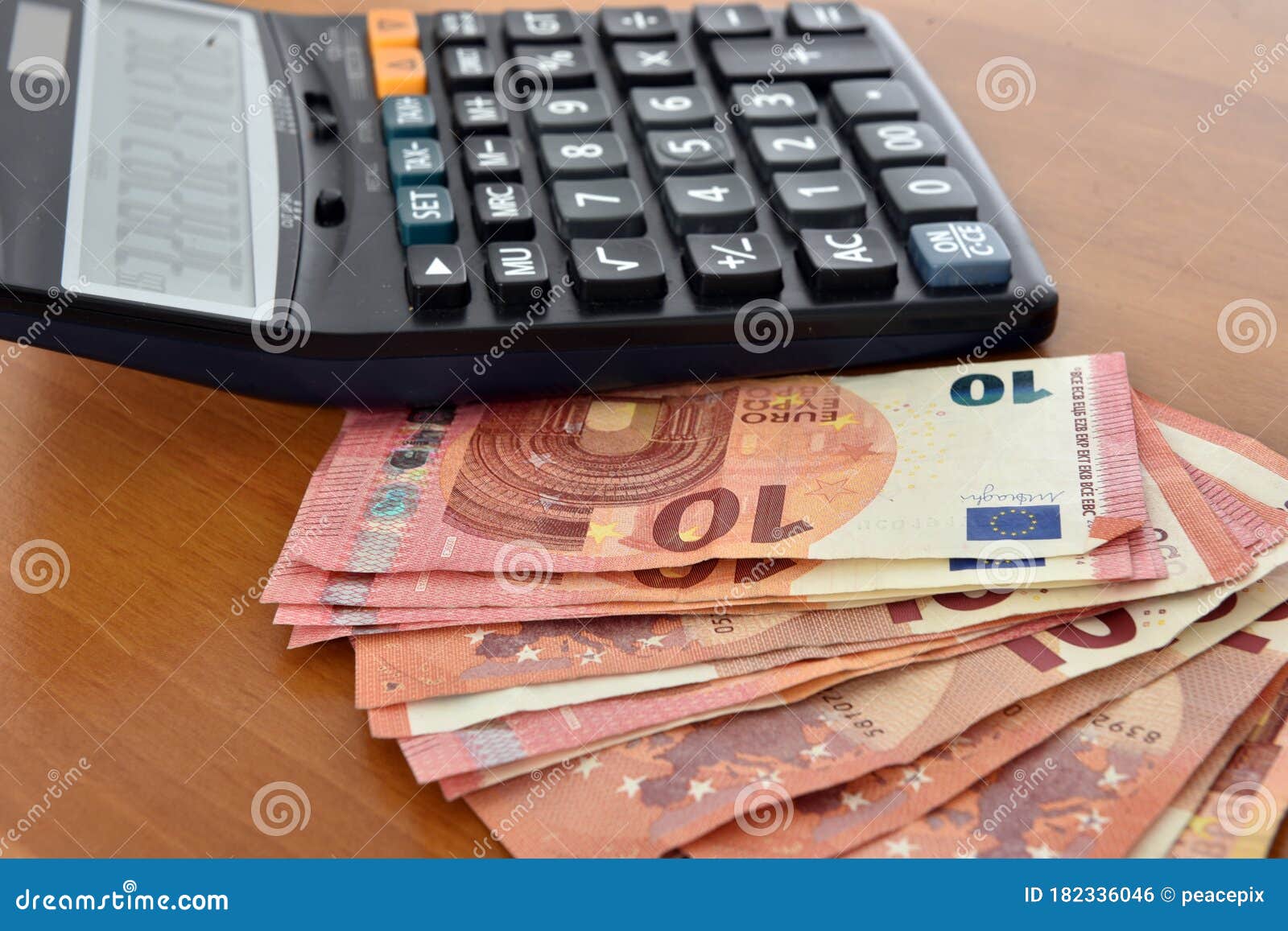 close-up of a calculator and 10 euros bills.