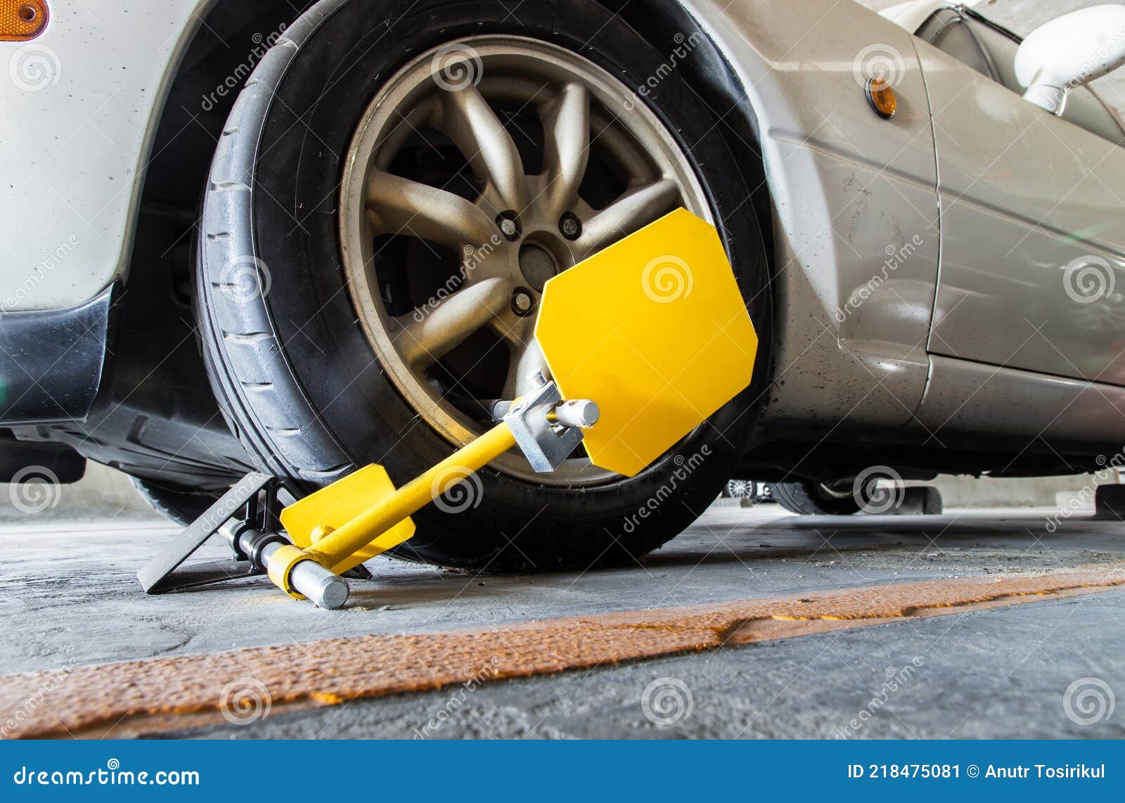 Closeup of Car Wheel Blocked by Wheel Lock because Illegal Parking