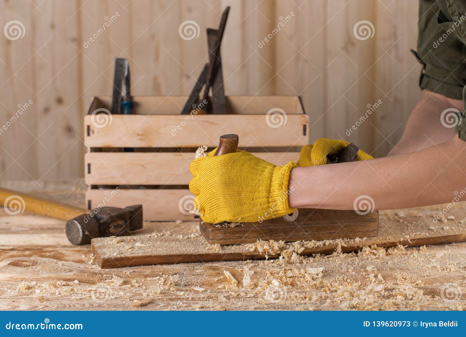 Close Up of a Carpenter Planing a Plank of Wood with a Hand Plane Stock