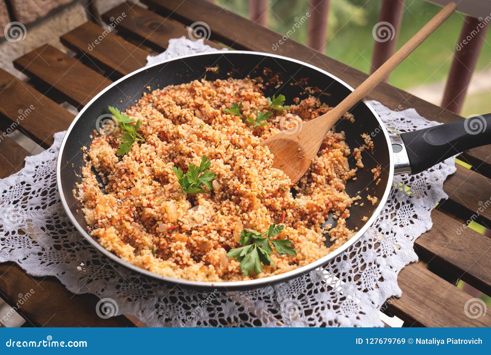 Closeup of a Castiron Frying Pan with Couscous and Cherry Tomatoes
