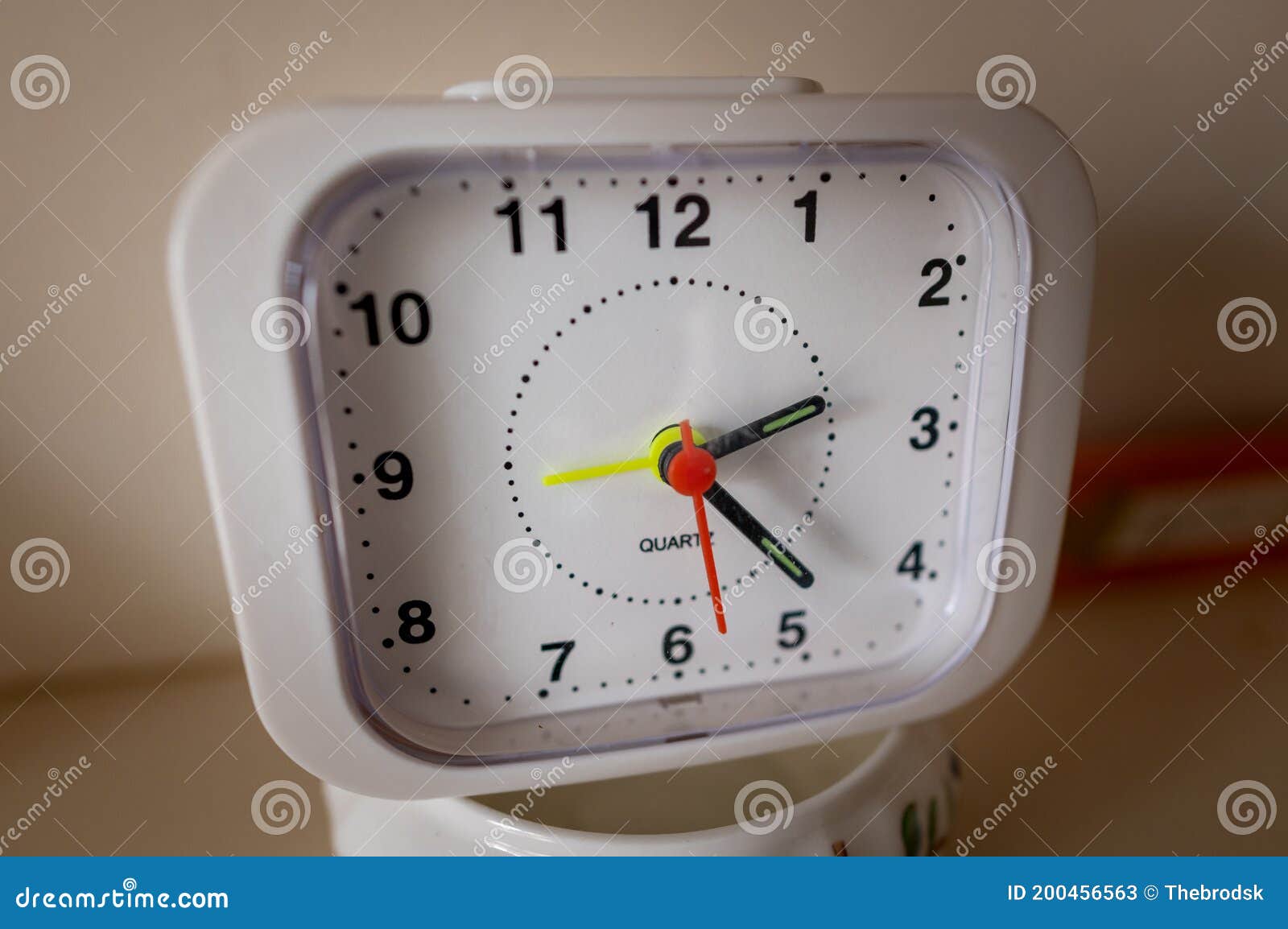 Close Up of an Cheap Square Shaped Clock Showing Time 223 Stock Image
