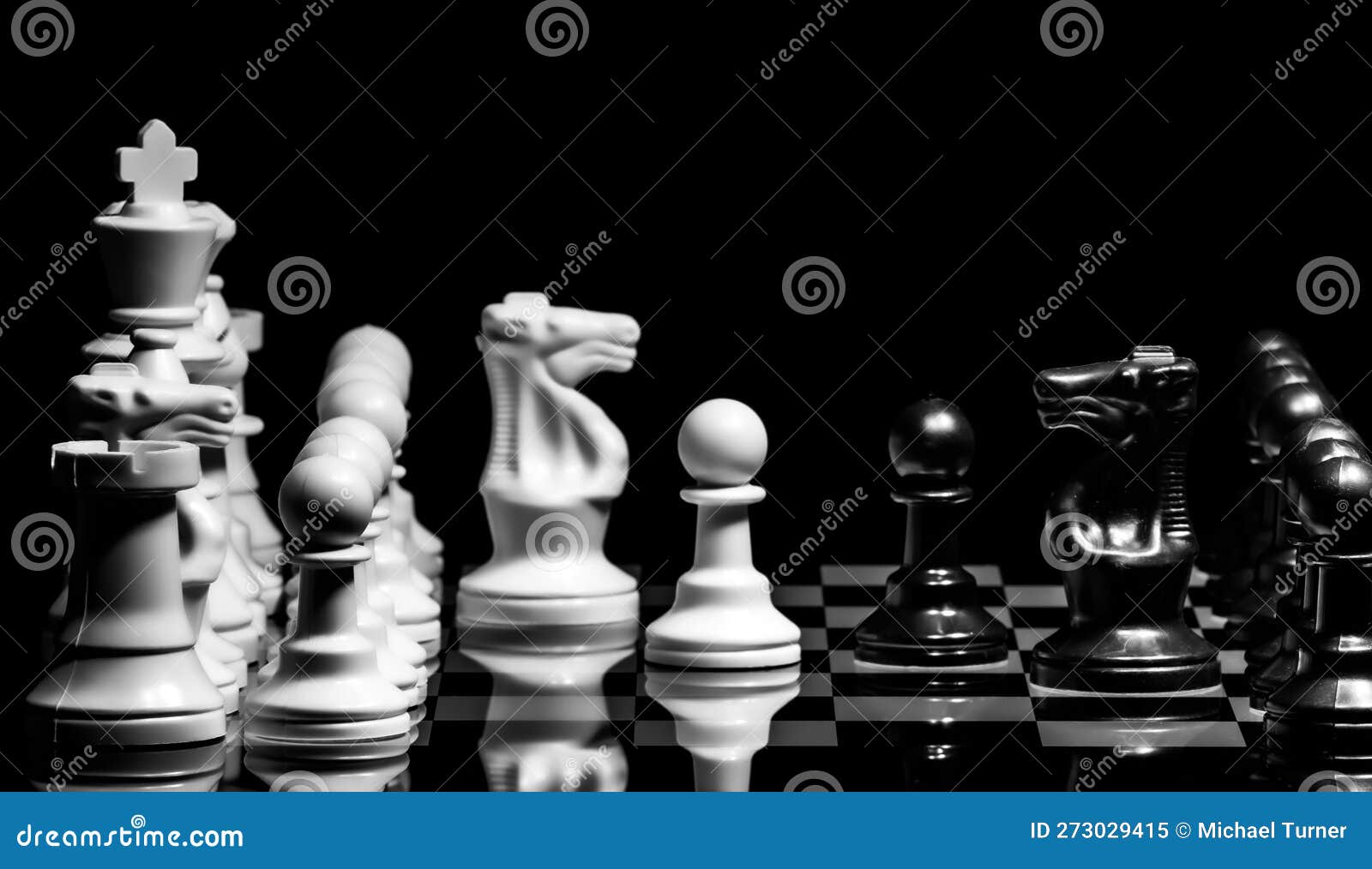 Close Up of Chess Pieces on a Reflective Mirror Board Surface Wi Stock