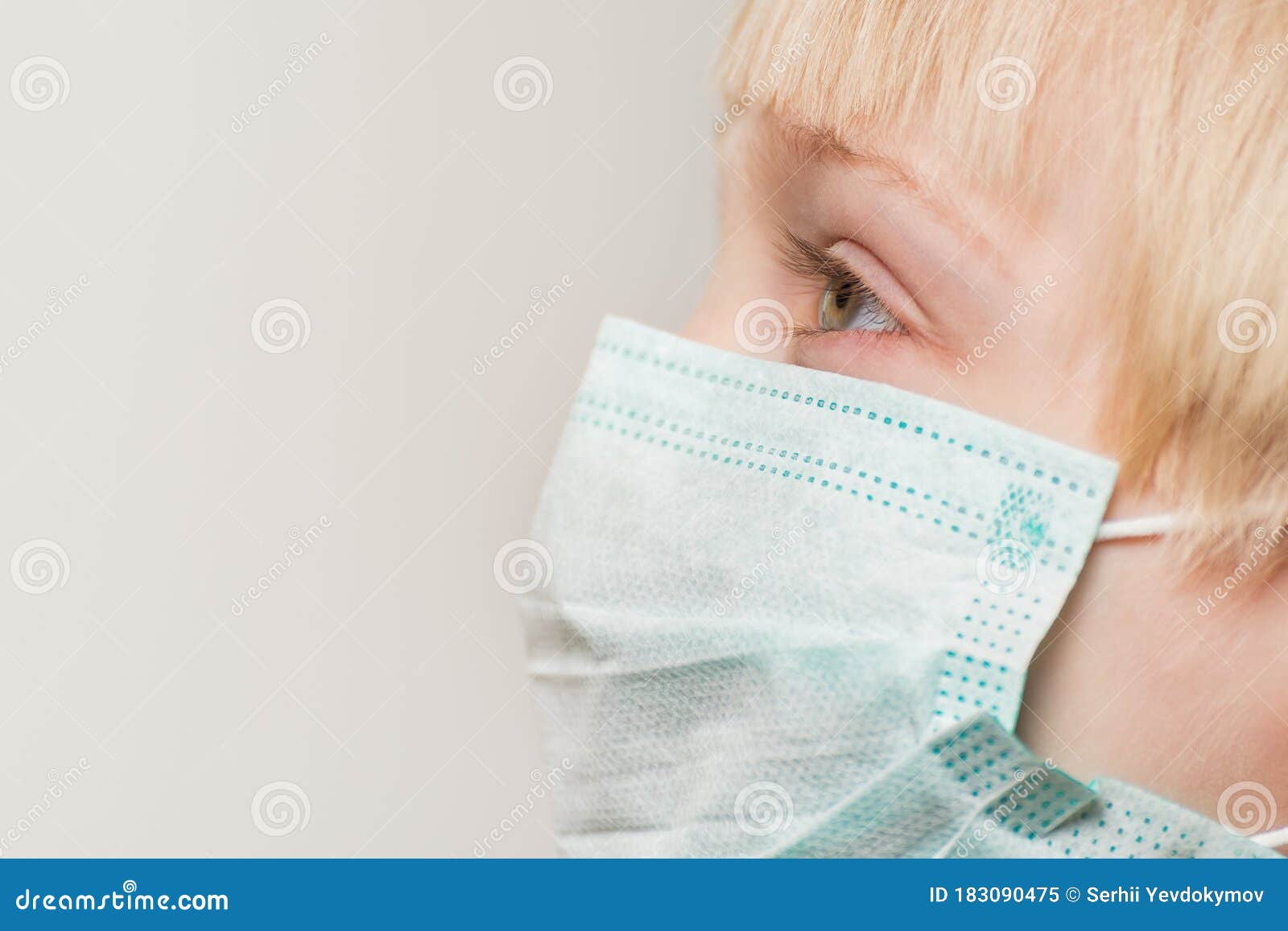 close up of child face in surgical mask, white background. prevention of bacterial infection covid 19