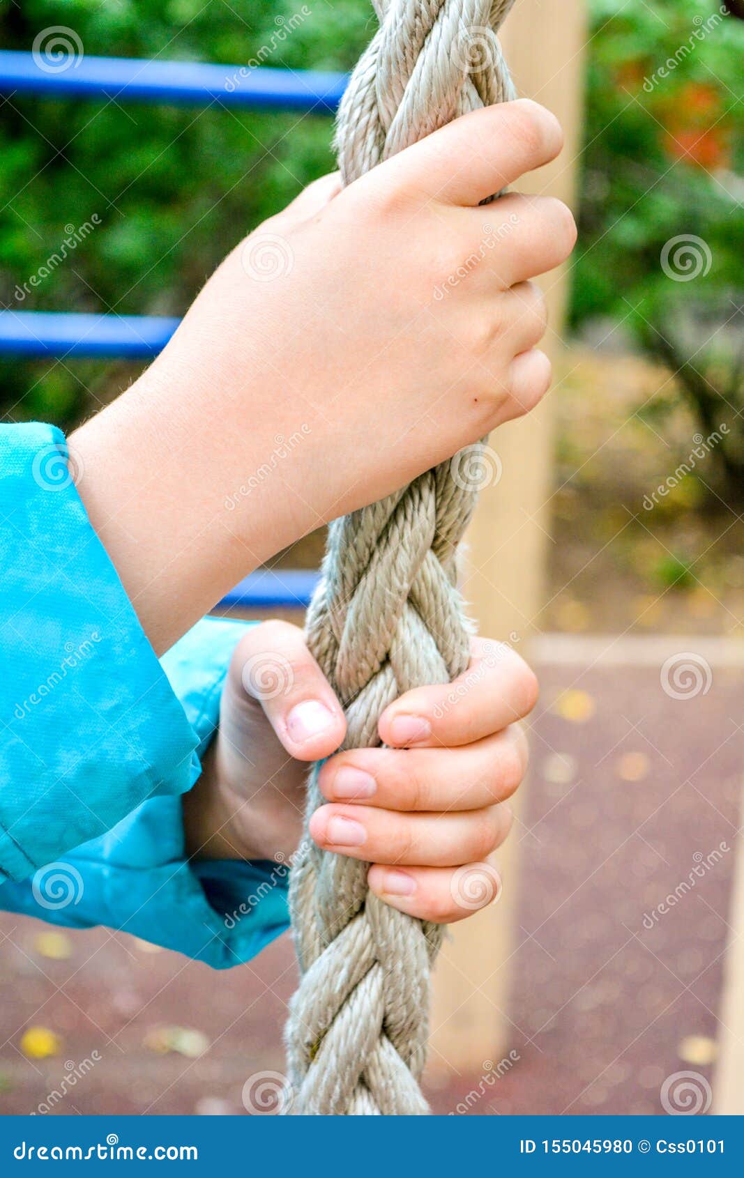 Child Hands Clings To Thick Rope for Climbing of Sports Equipment