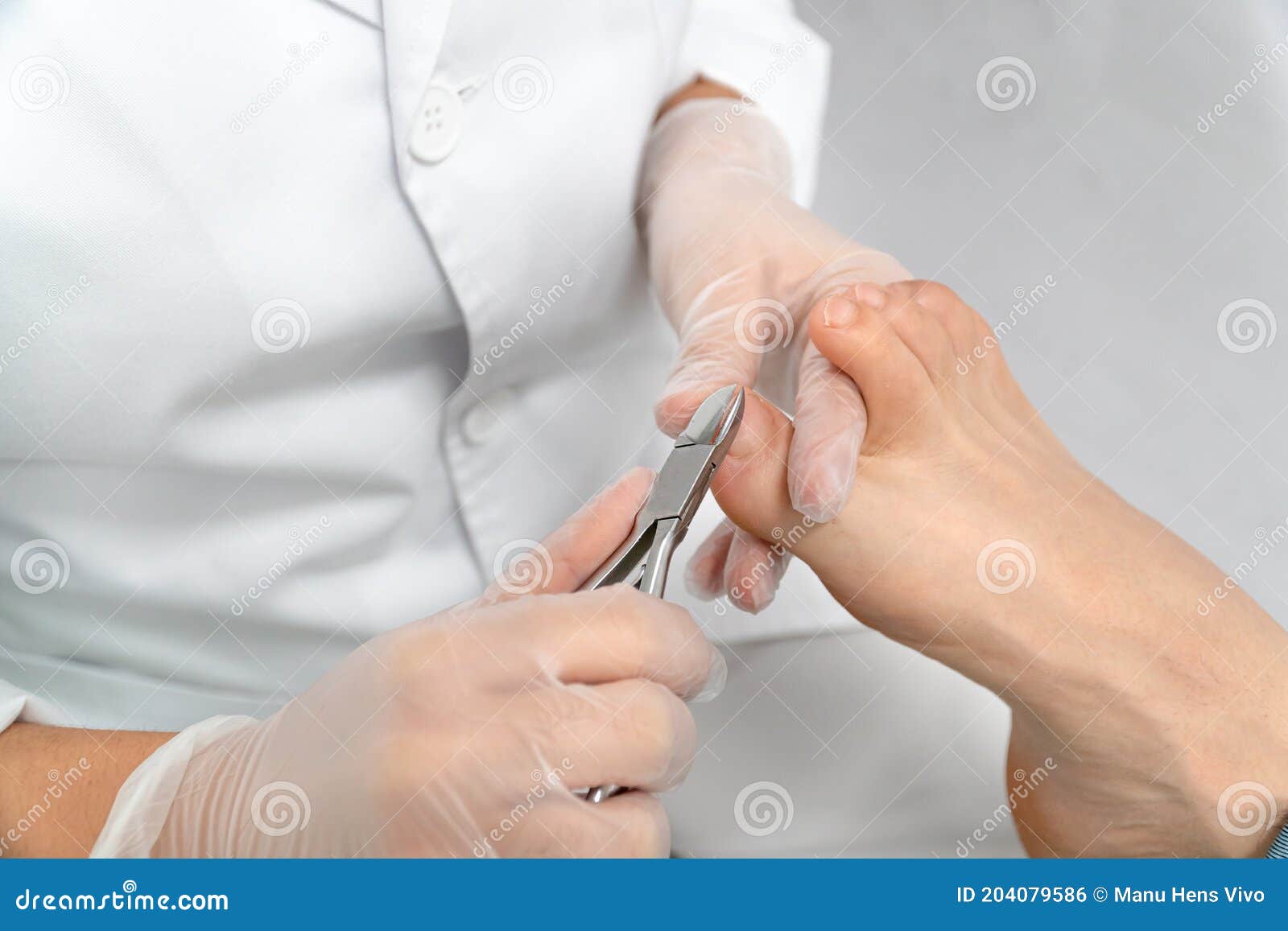 close up of a chiropodist`s hands doing chiropody in her podiatry clinic