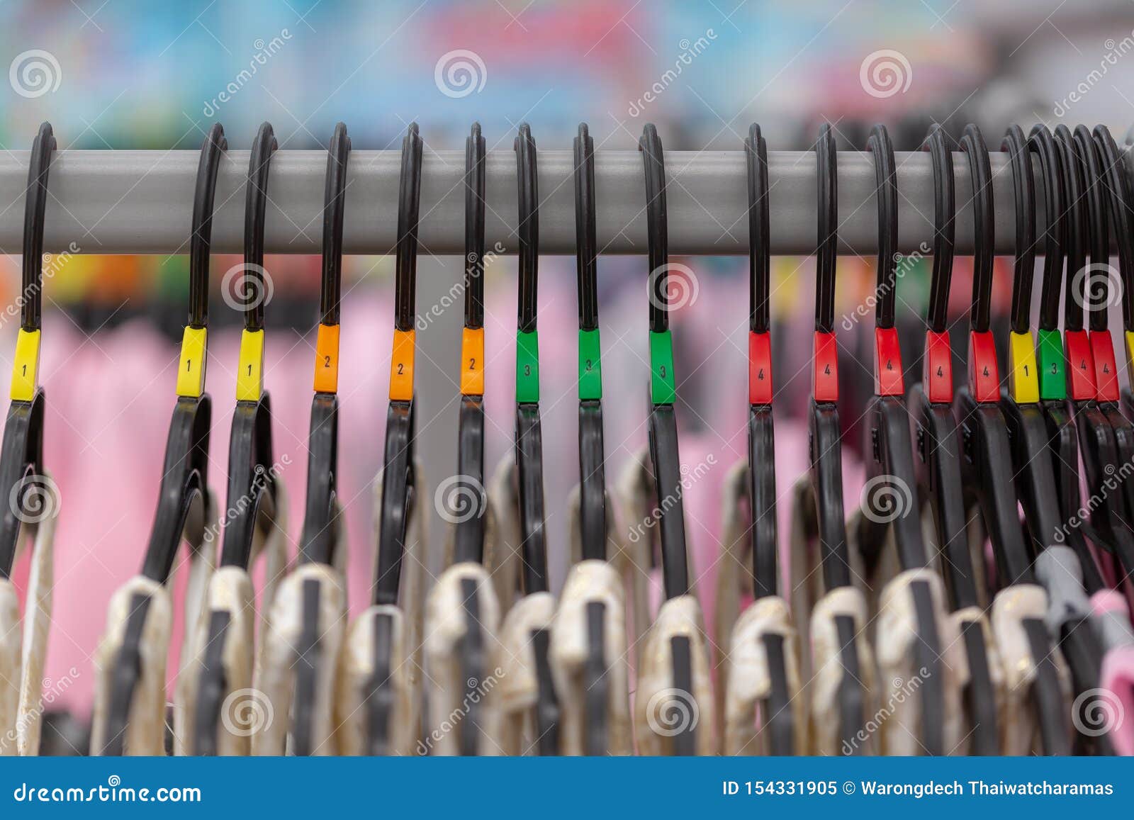 Close Up of a Clothing Rack with Hangers Showing Different Clothing