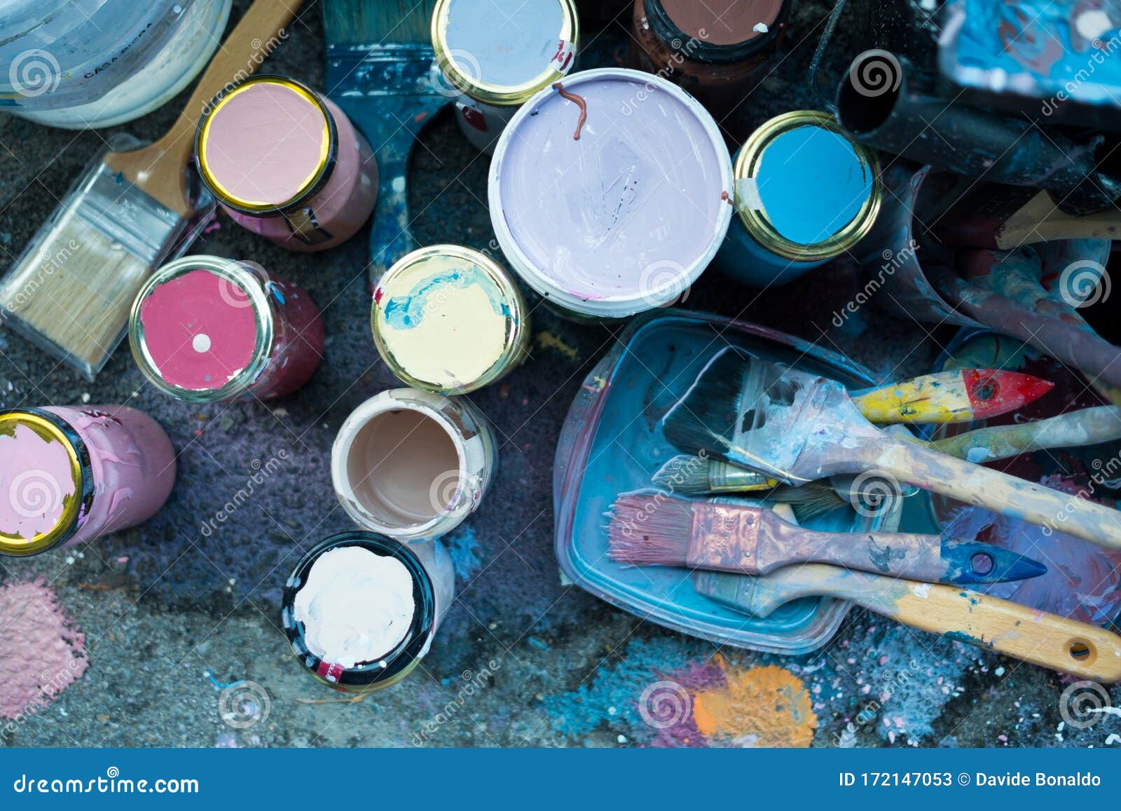 Close Up Of Colorful Bunch Of Brushes And Paint On Floor With