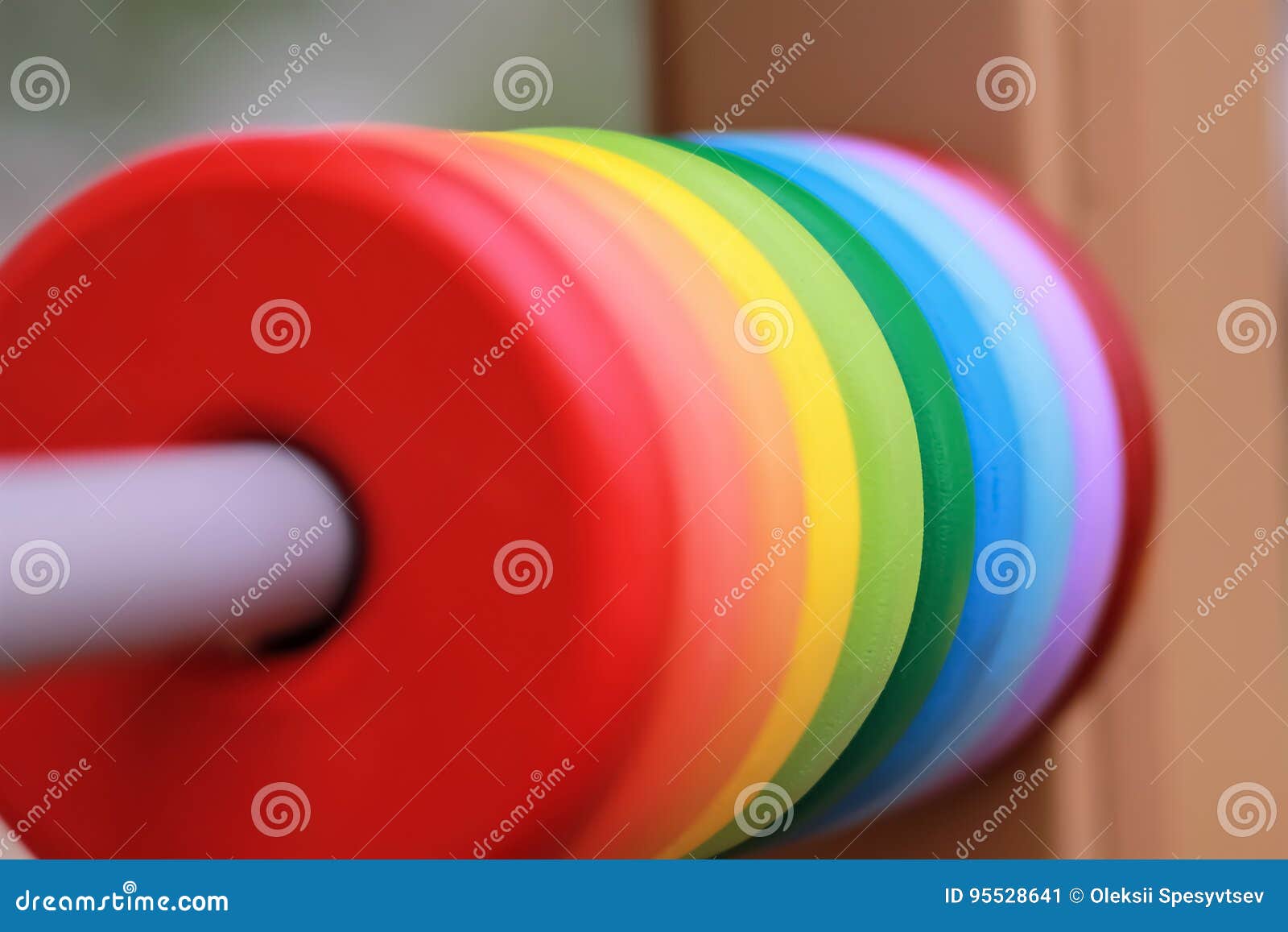 close up of colorful rainbow wooden circles on the playground