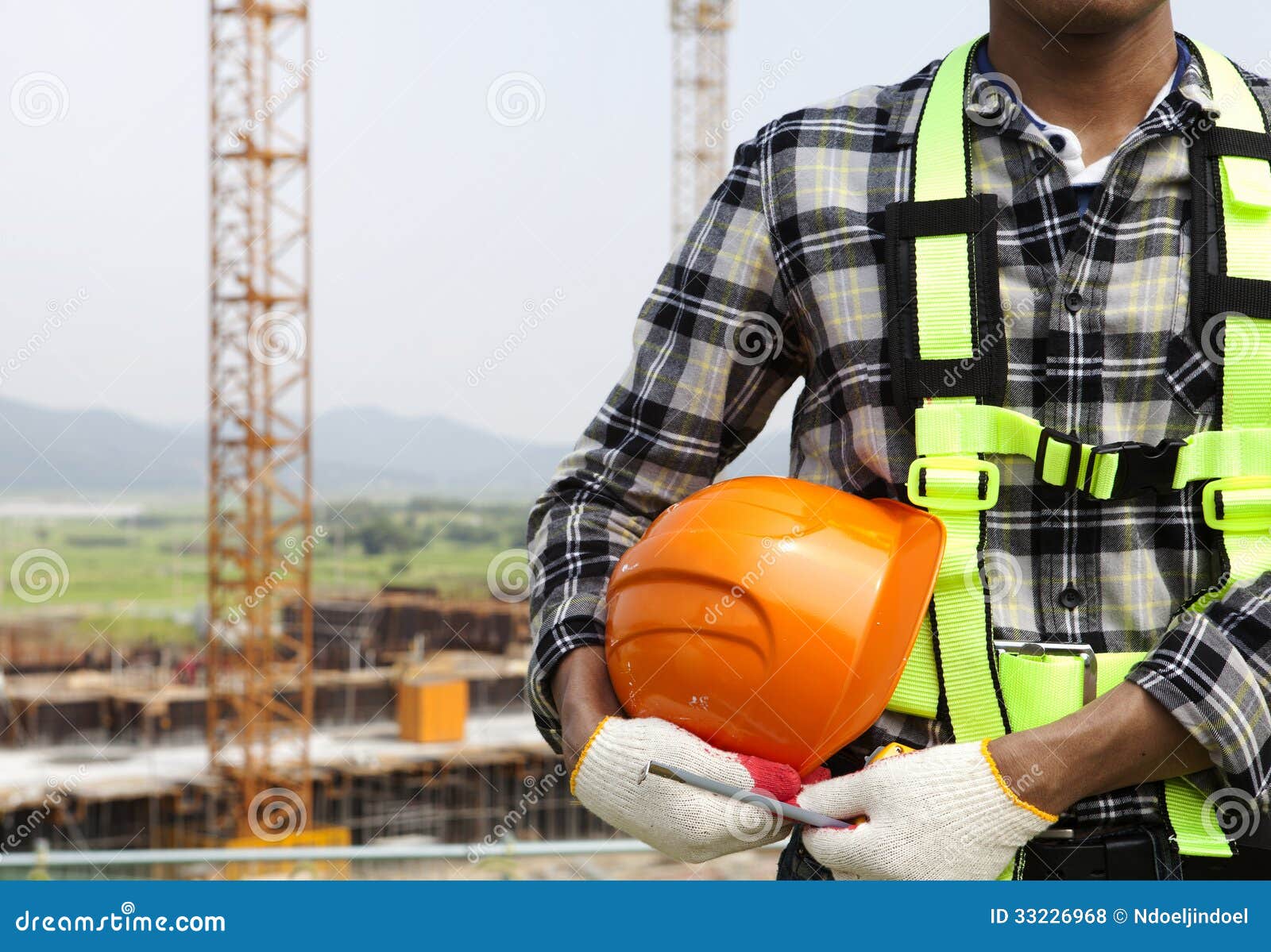close up construction worker holding helmet