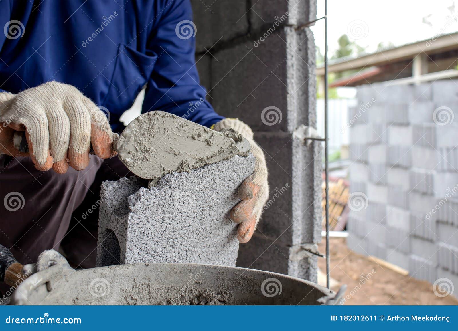 Closeup of Construction Workers Using Cement Trowel on the Brick To
