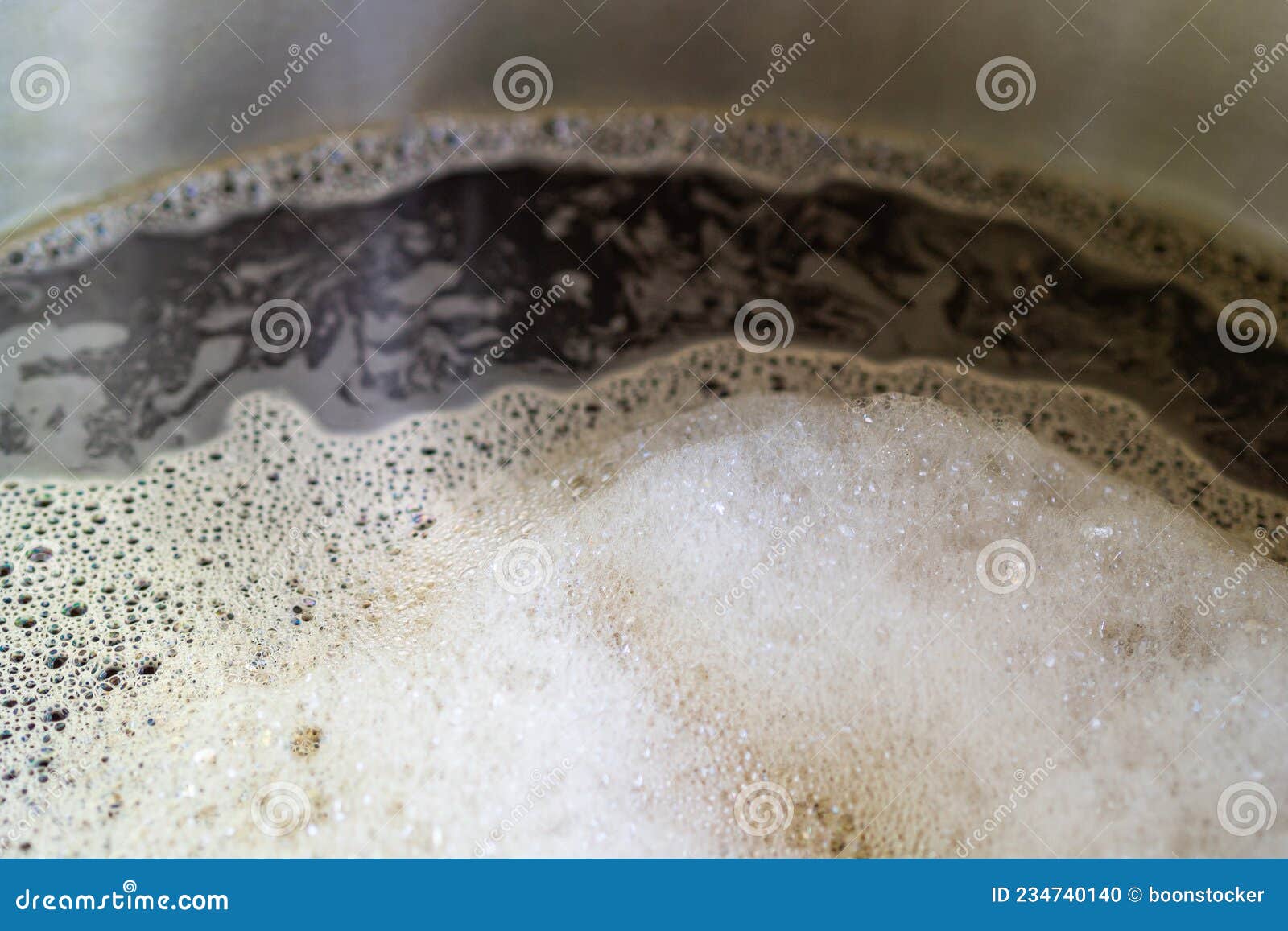 Closeup of Craft Beer and Foam in a Fermentation Container. Process of Making Home Beer from