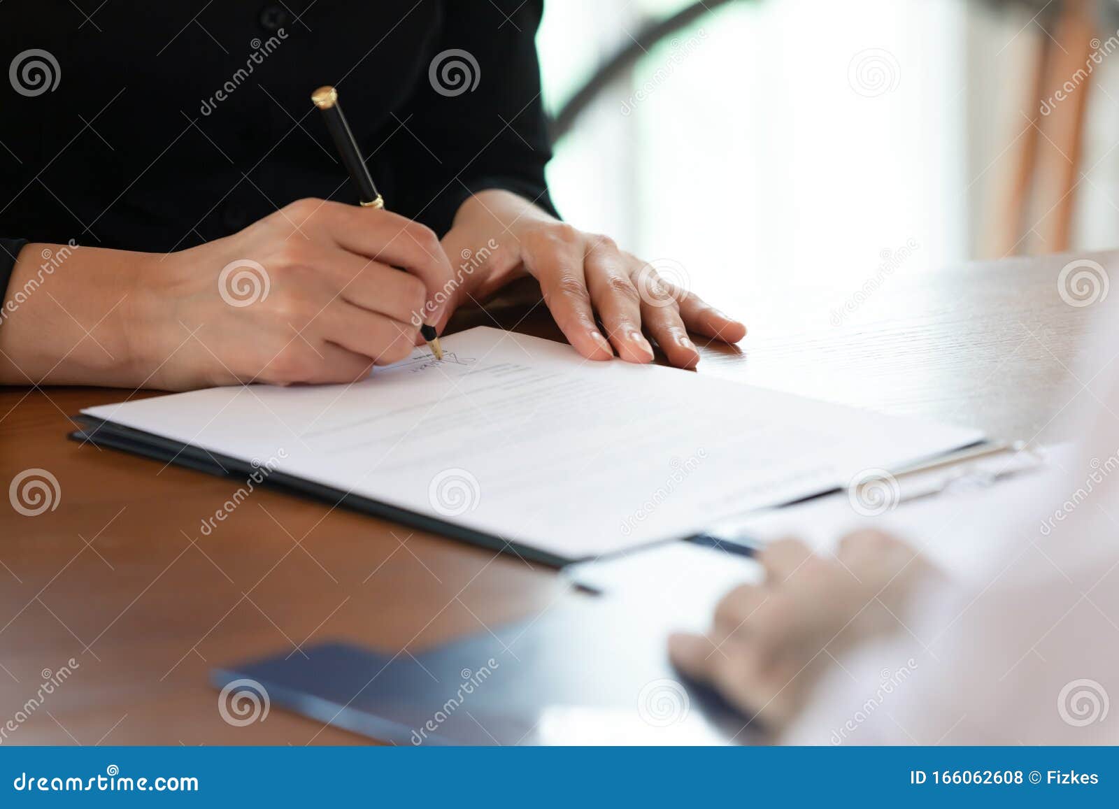 close up cropped image young woman signing business agreement.