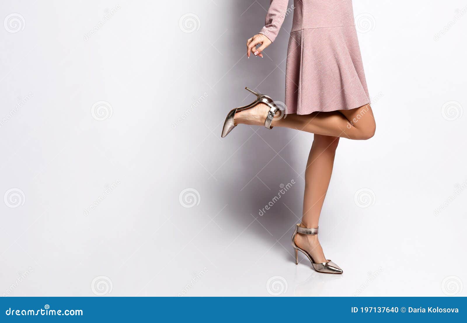 Long Woman Legs On White Pink Gumshoes On Side View Stock Photo