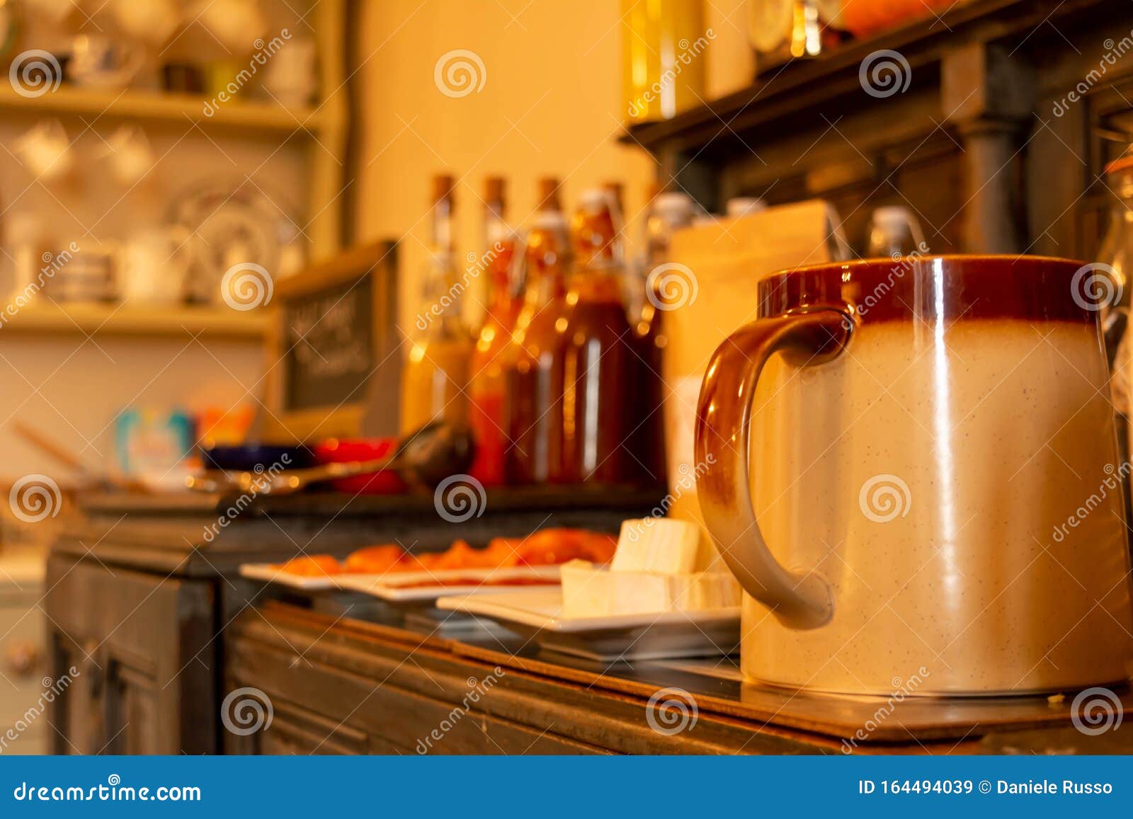 close up of cup and bottles of marmelade for breackfast in english cottage in countryside