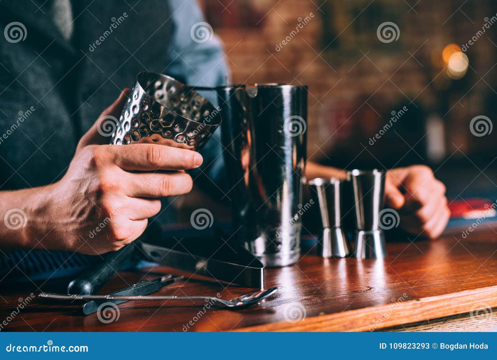 Close Up Details of Barman Hands Using Cocktail Tools. Professional Bartender Working at Bar