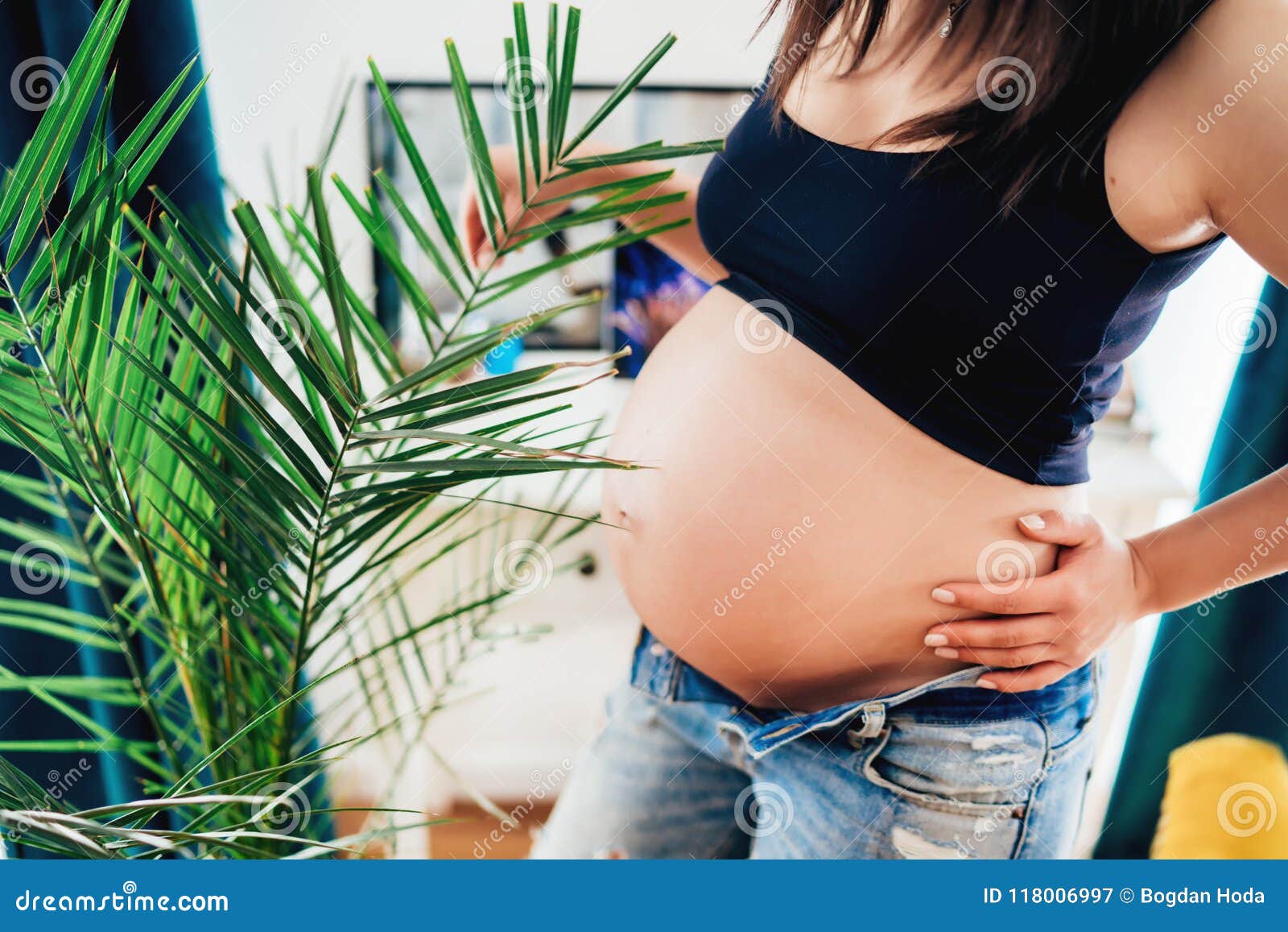 close up details of pregnant woman in new home - concept of pregnancy, maternity and motherhood health care, gynaecology, medicine