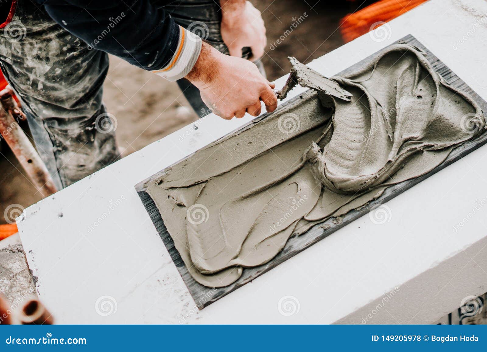 Details of Worker Using Trowel and Mortar for Stone Installation Stock