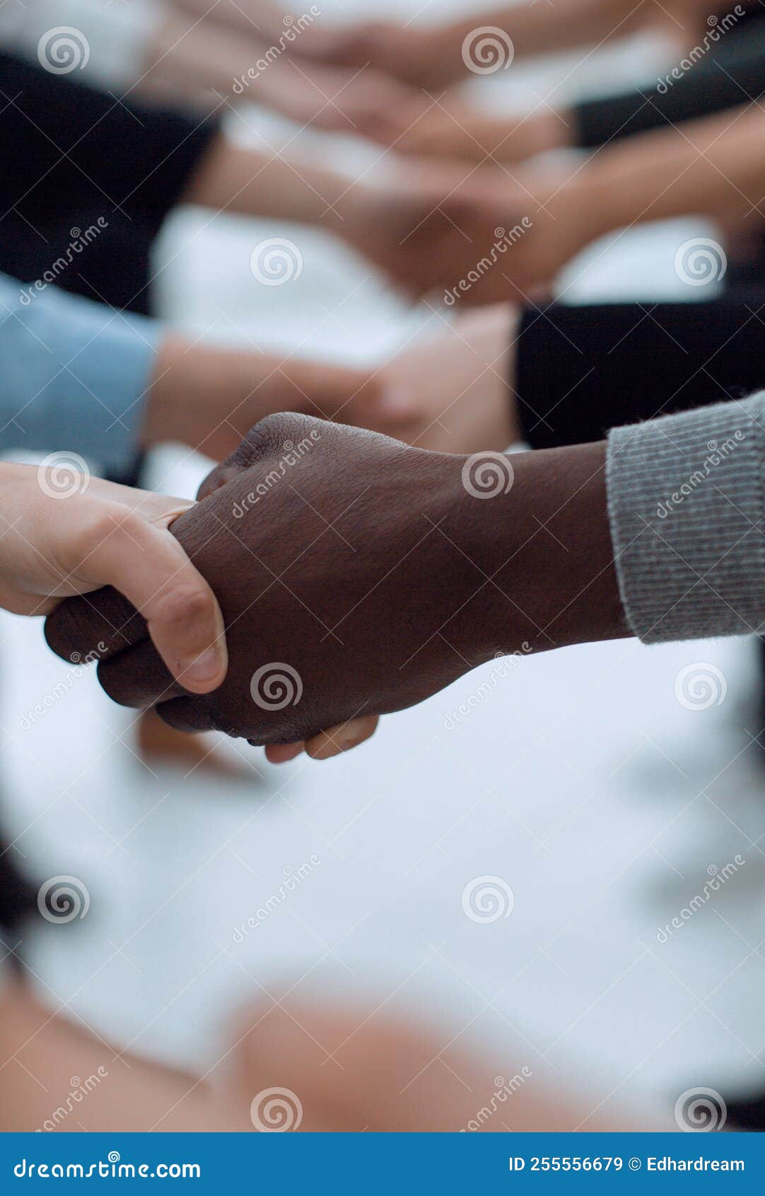 Close Up. Diverse Young People Shaking Hands with Each Other Stock