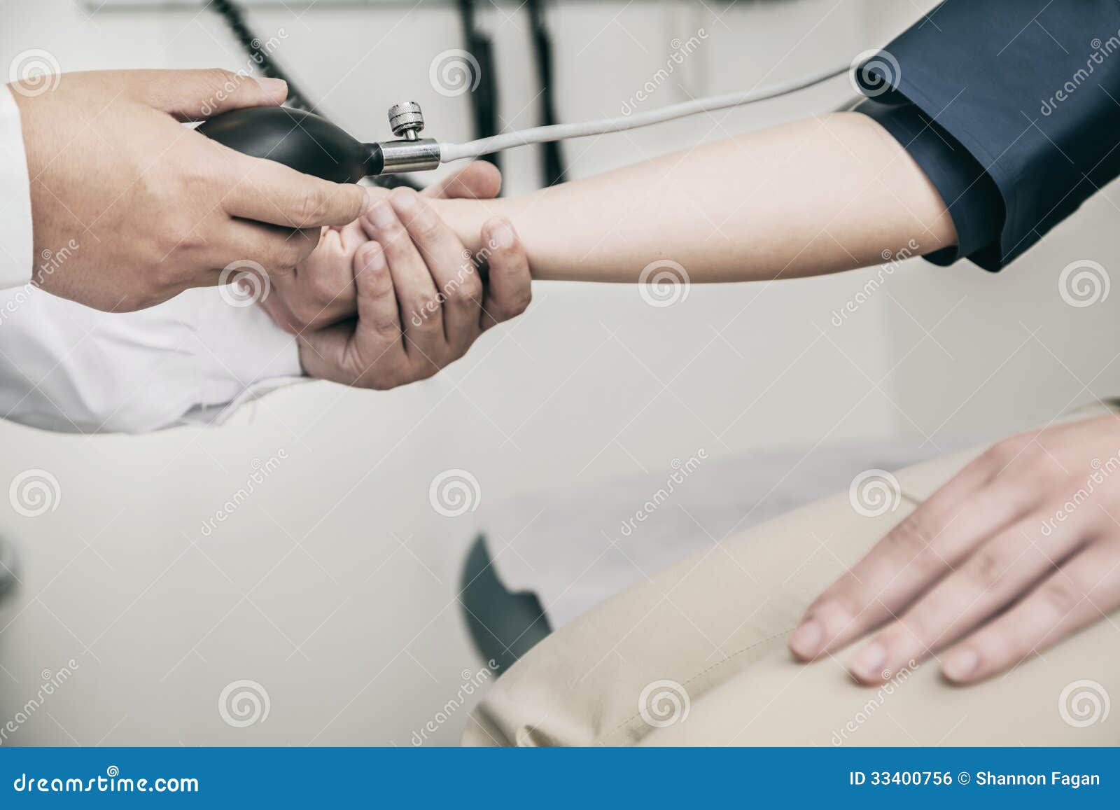 Closeup of Doctor Checking Blood Pressure on the Arm Stock Photo