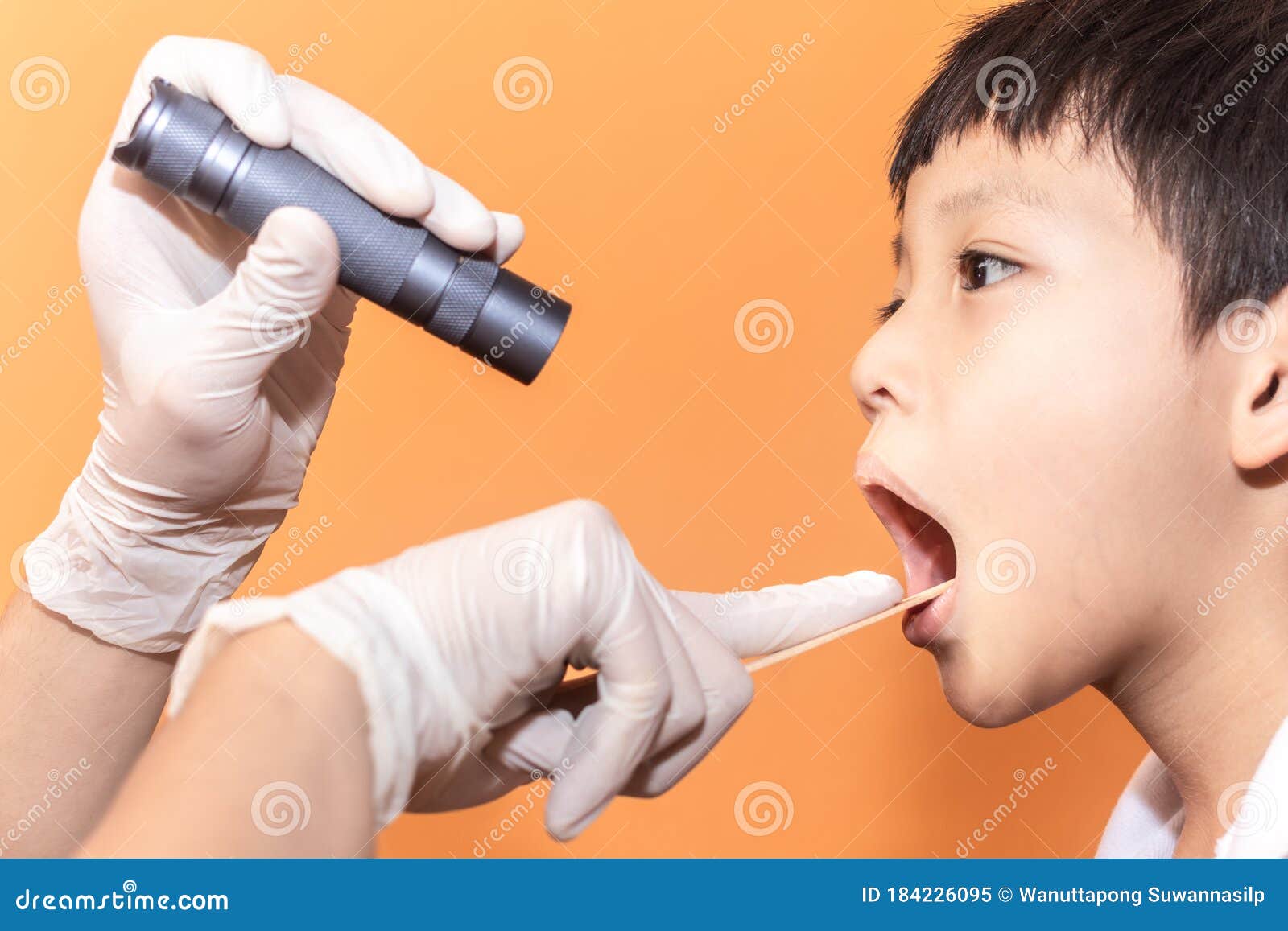 close up doctor examining throat of patient with tongue depressor