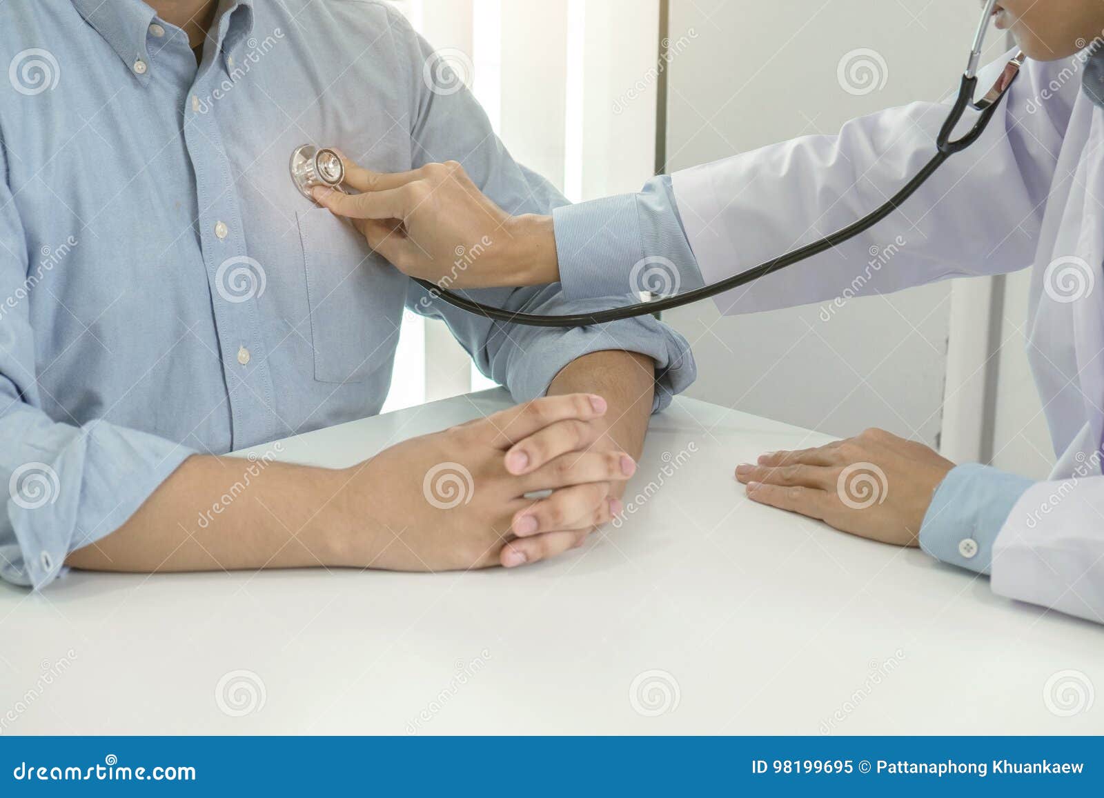 Close Up Of Doctor Listening To Patient Heartbeat With Stethoscope On Hospital Physical