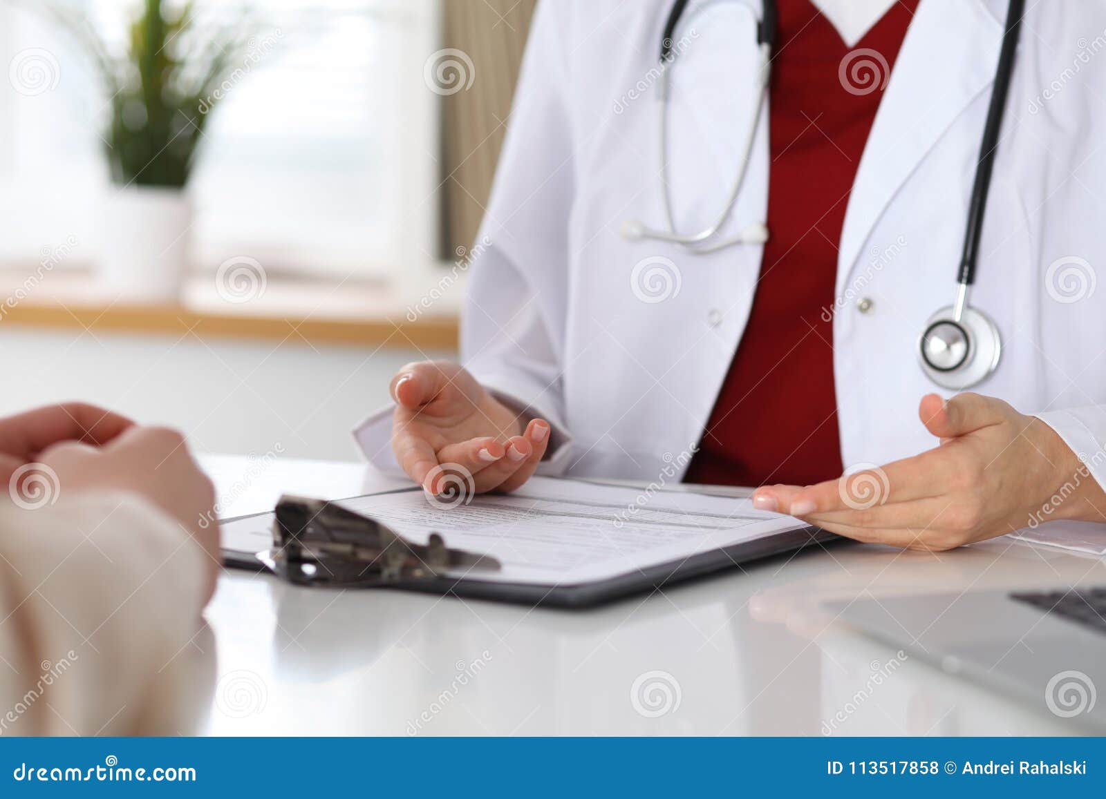 close up of a doctor and patient hands while discussing medical records after health examination