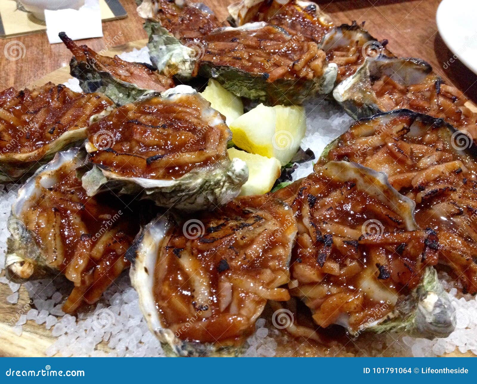 close up dozen oysters kilpatrick in shells on bed sea salt