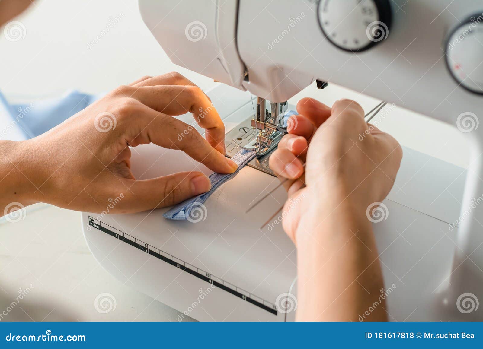 Close Up Dressmaker is Process Electric Sewing Machine with Fabric and