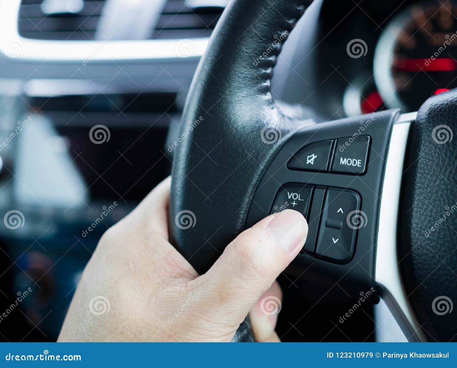 Driver`s Hands Press Volume Button on a Steering Wheel Stock Image