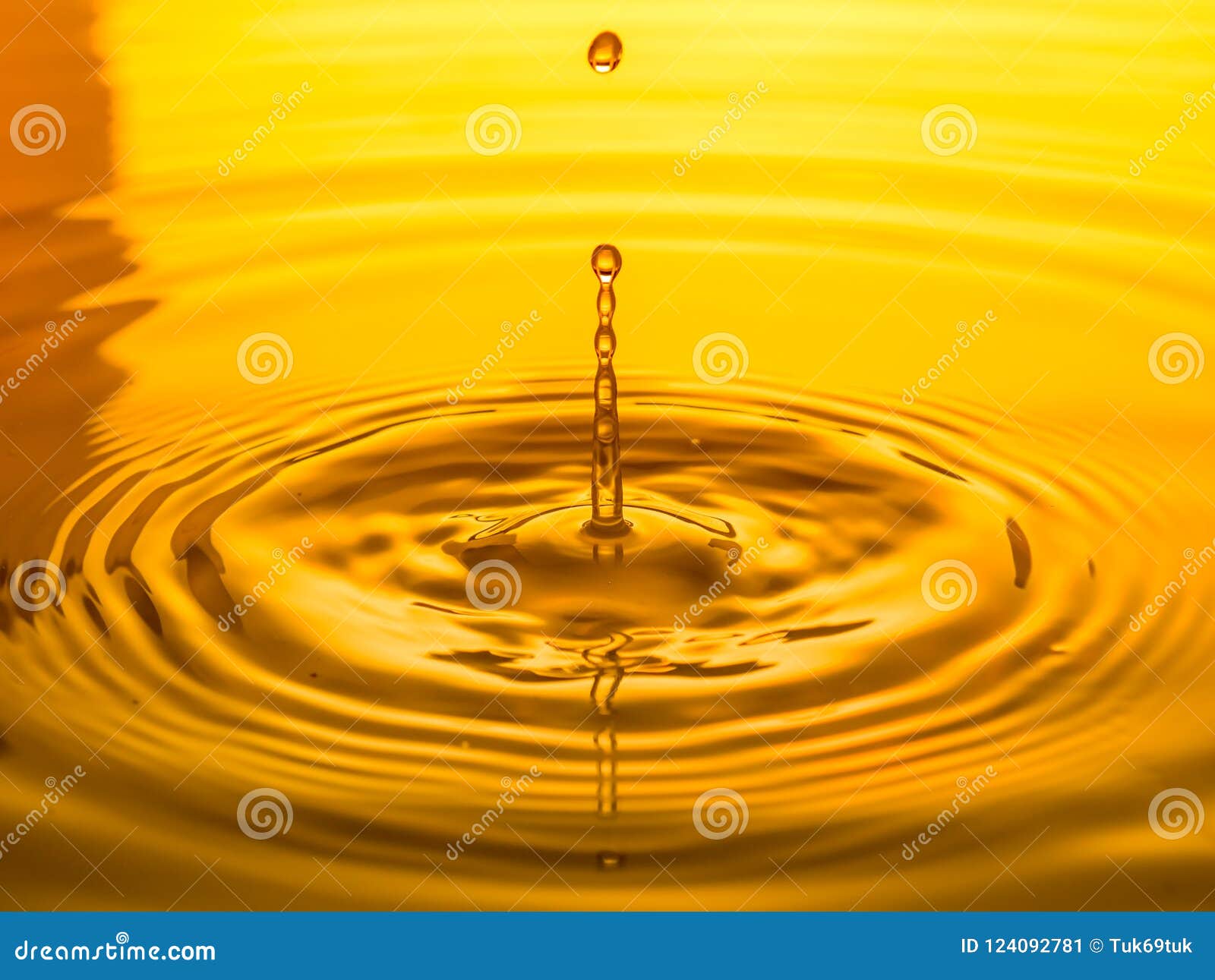 Close Up of a Drop Oil on a Yellow Background Stock Image Image of