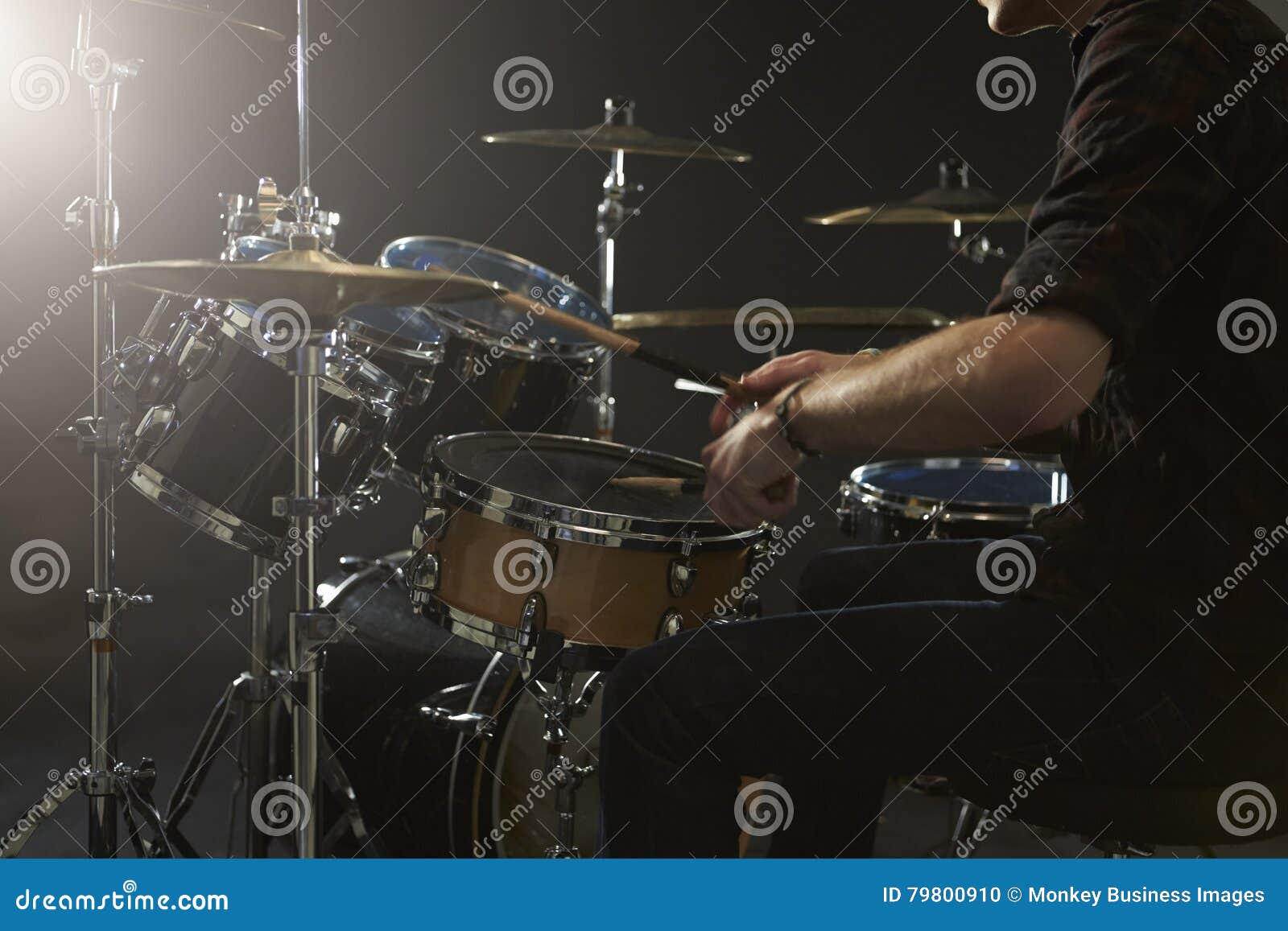 close up of drummer playing drum kit in studio