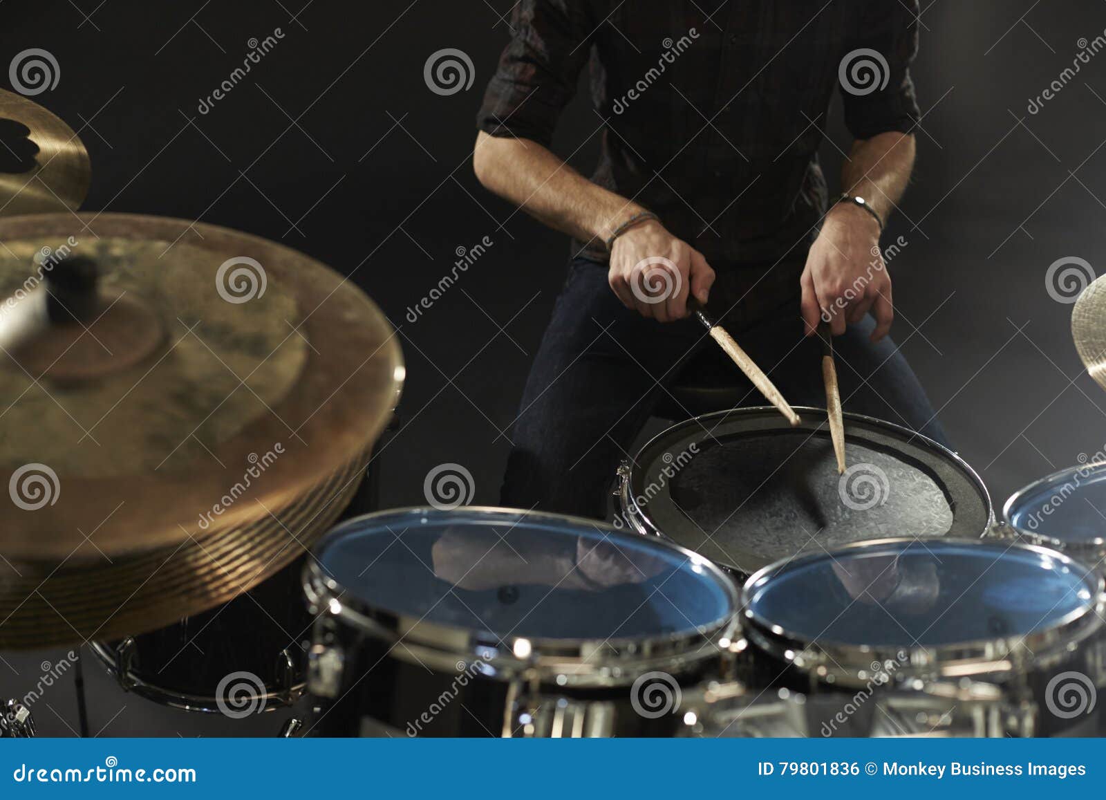 close up of drummer playing snare drum on kit in studio