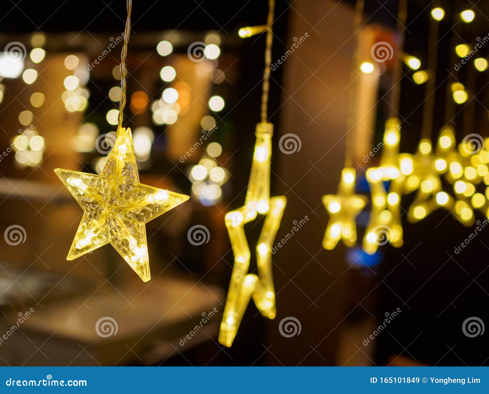 Close Up of Electric Lighted Stars with Warm Yellow Lights Against a ...