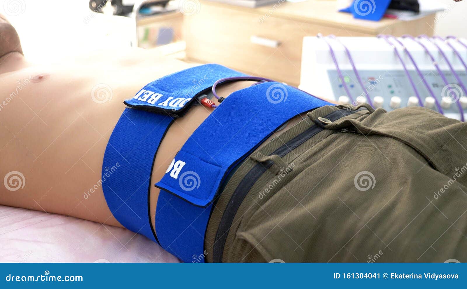 Closeup. Electrical Stimulation Procedure for Abdominal Muscles. a Man