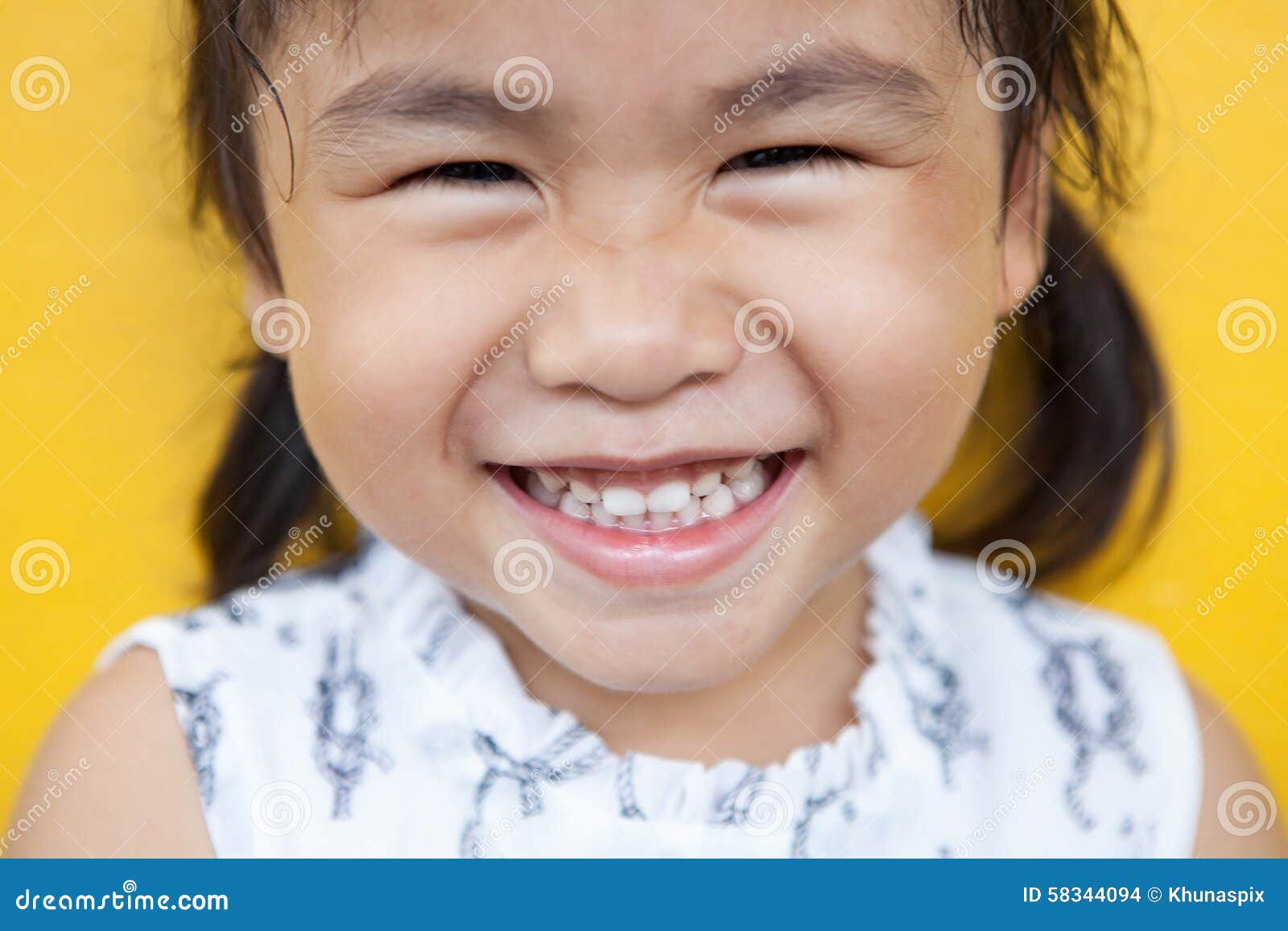 close up face of asian kid toothy smiling facial face with happi