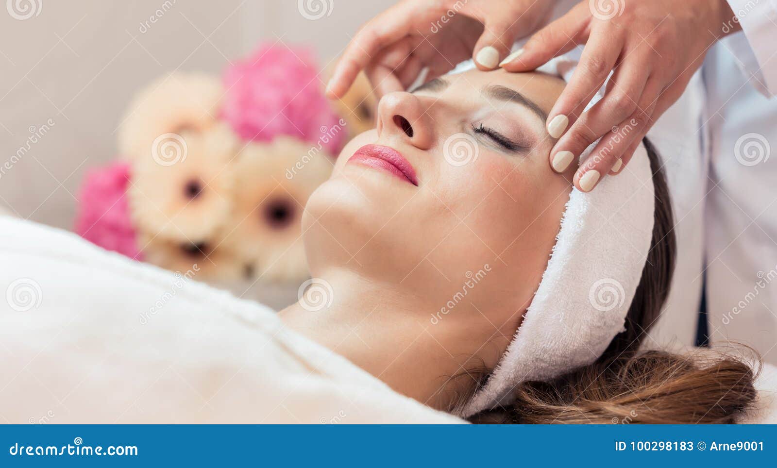 Beautiful Woman Relaxing During Rejuvenating Facial Massage In A Stock