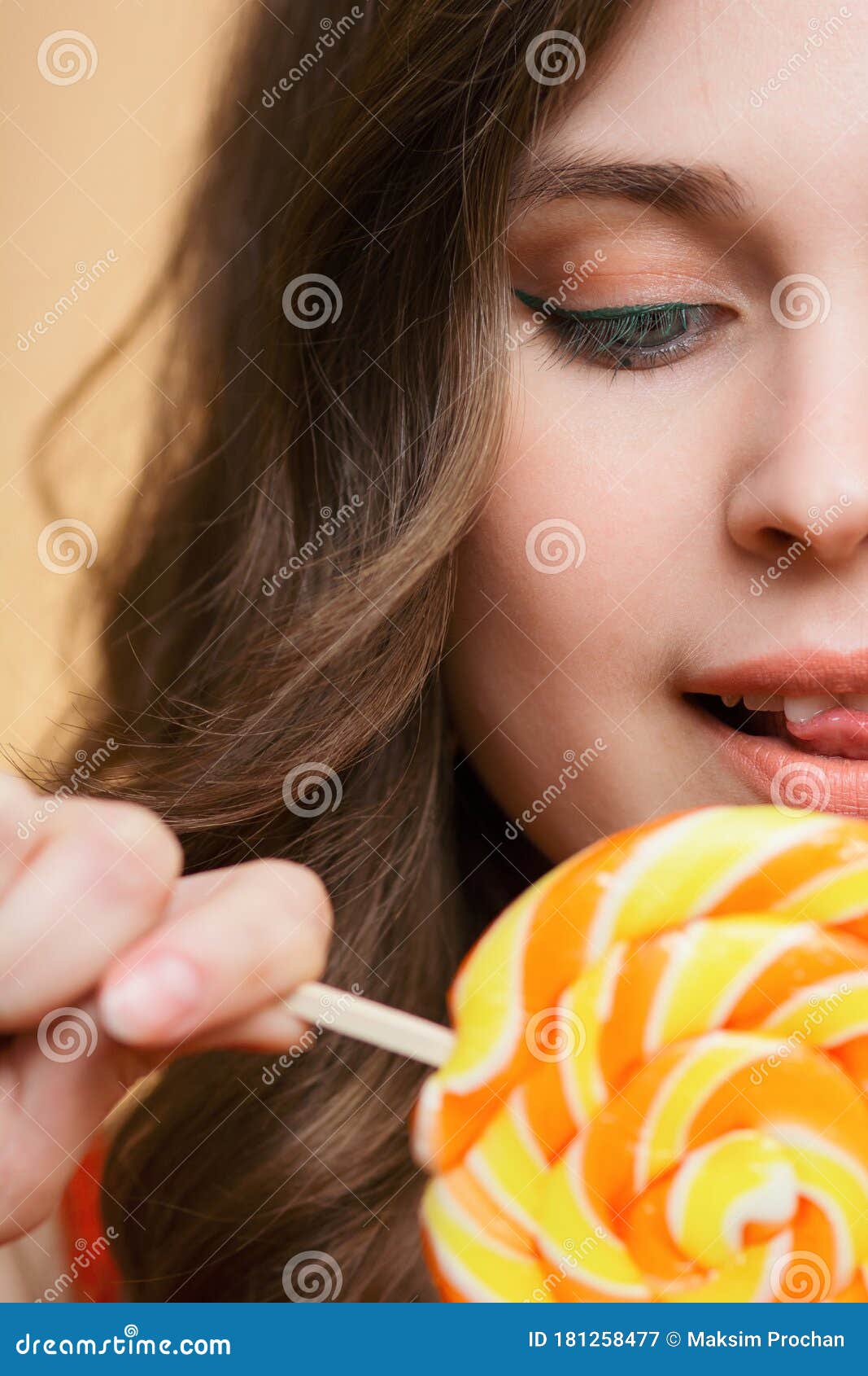 Close-up Face of Cute Beautiful Girl with Round Caramel on Colored ...
