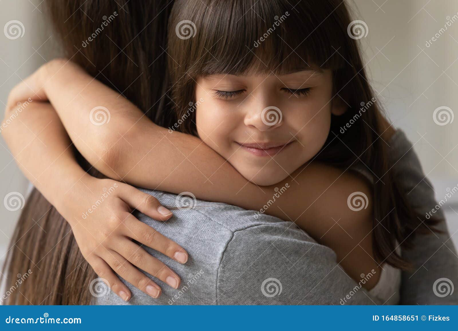 close up face of daughter cuddle her mother heartfelt moment