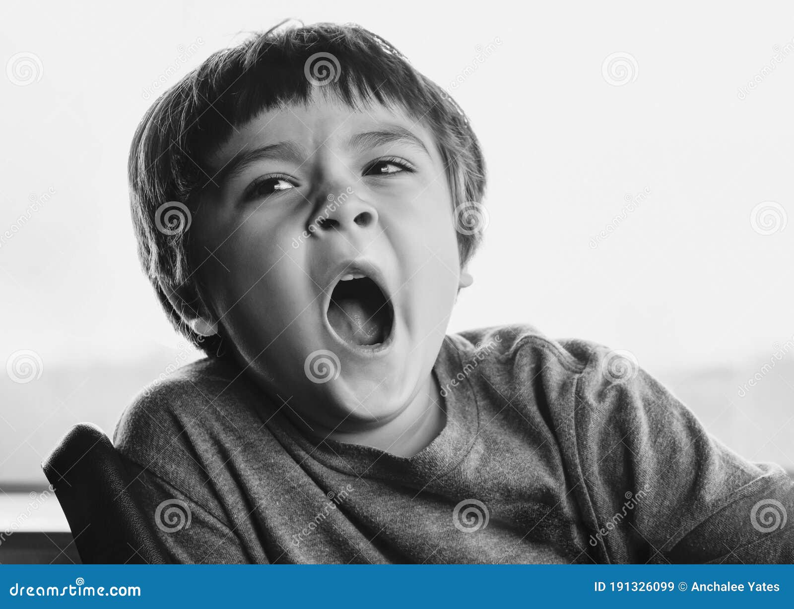 Close Up Face Of Kid Yawning Lying Sleepy Child Yawning And Looking