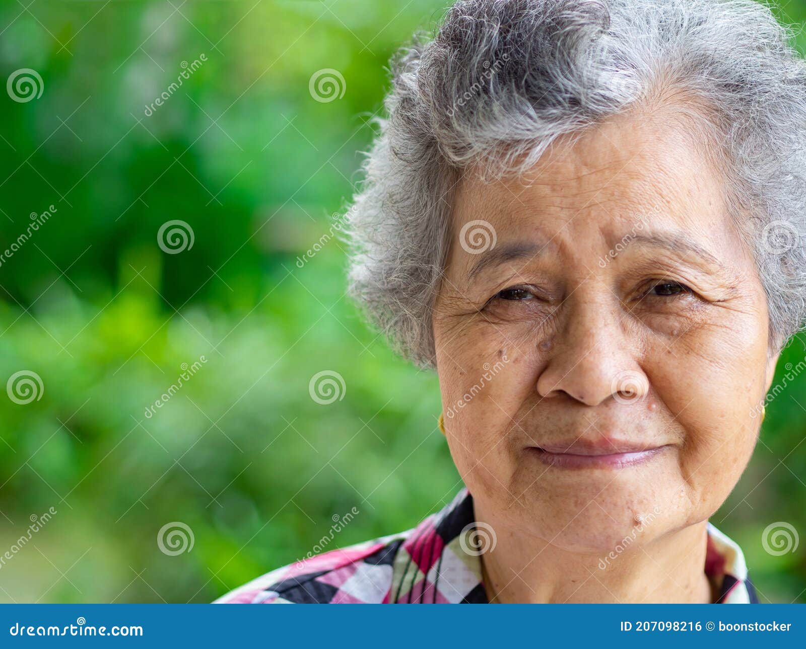 close-up face of a senior woman smiling and looking at the camera. space for text. concept of aged people and healthcare