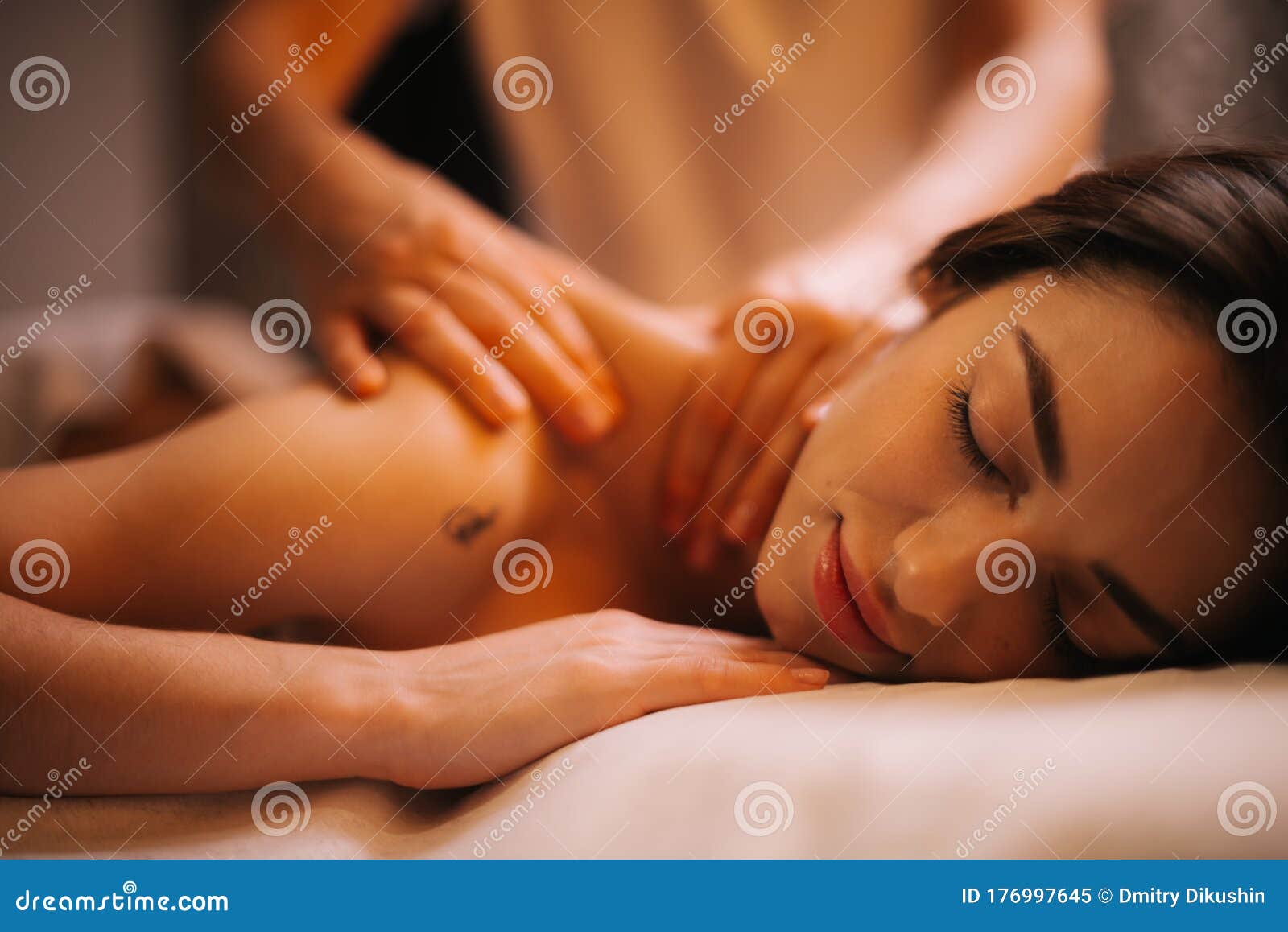 Close-up Hands Of Male Masseur Doing Back Massage To Young 