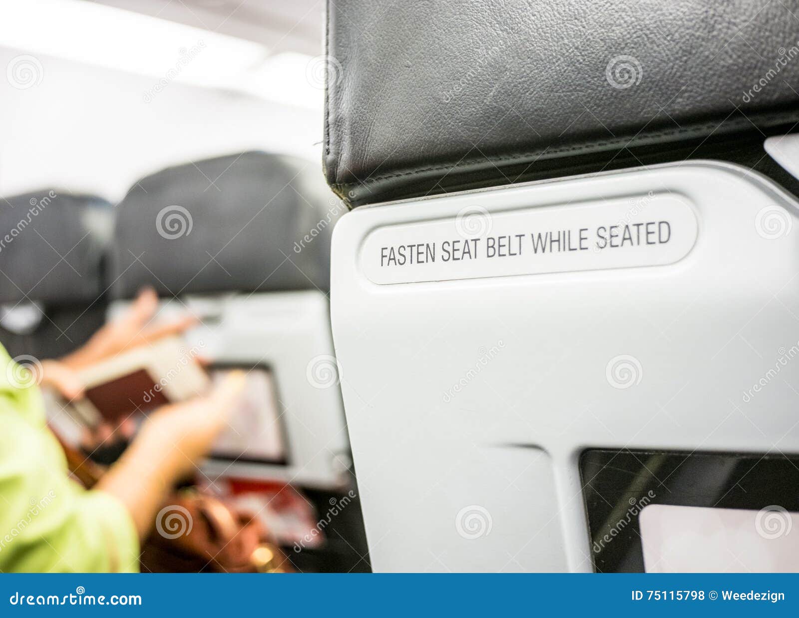 close up fasten seat belt at backrest on airplane